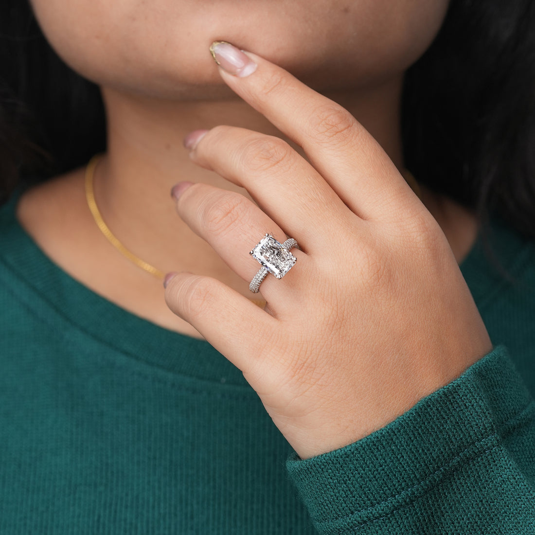 A sleek platinum ring showcasing a radiant-cut diamond and a sparkling pavé-set band for a refined, contemporary elegance.