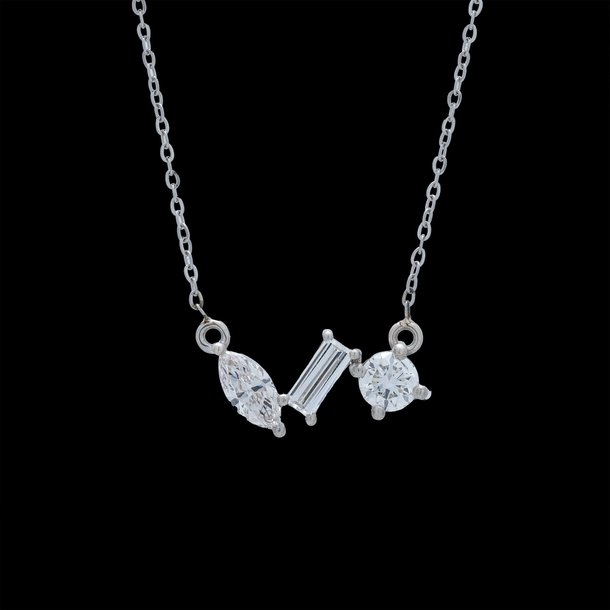 A luxury pendant necklace featuring lab-grown diamonds in round, marquise, and baguette cuts, elegantly worn on neck.
