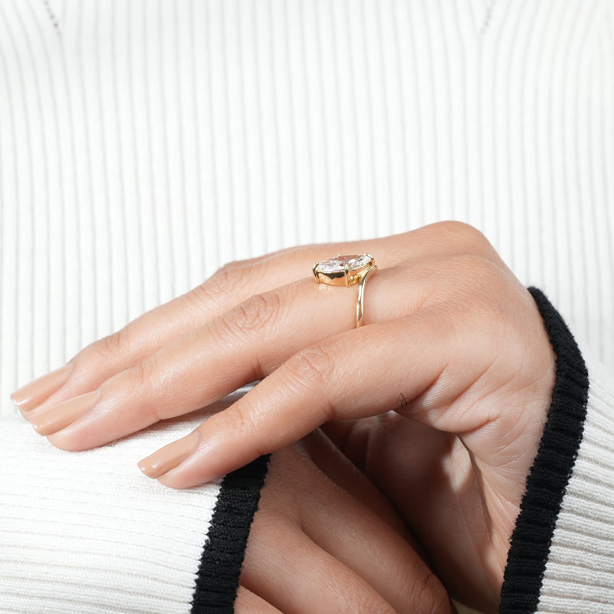Lyra Marquise Solitaire Lab Grown Diamond ring worn on hand, showcasing its elegant gold arc and minimalist design.