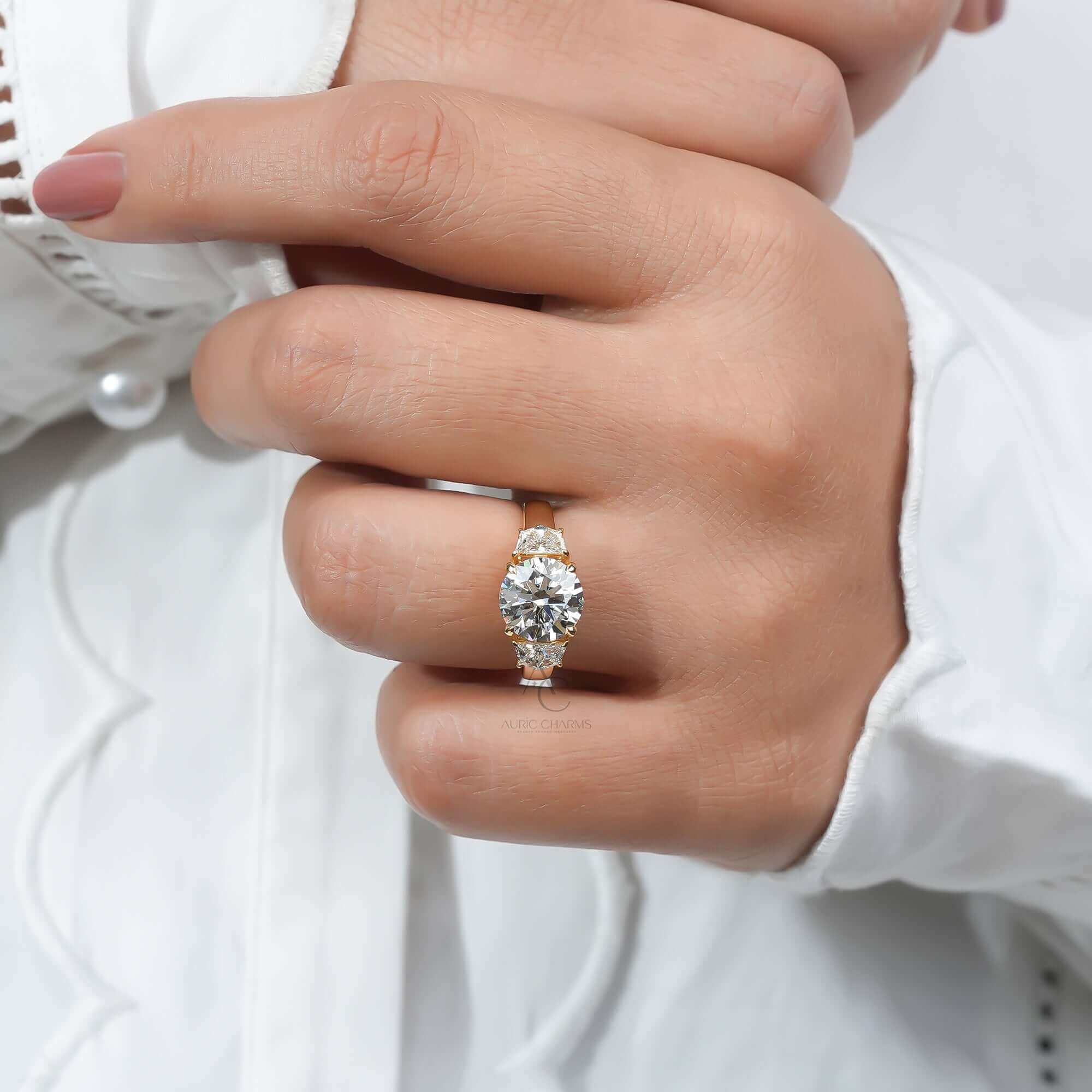 Diamond ring with side stones on finger, reflecting elegance.