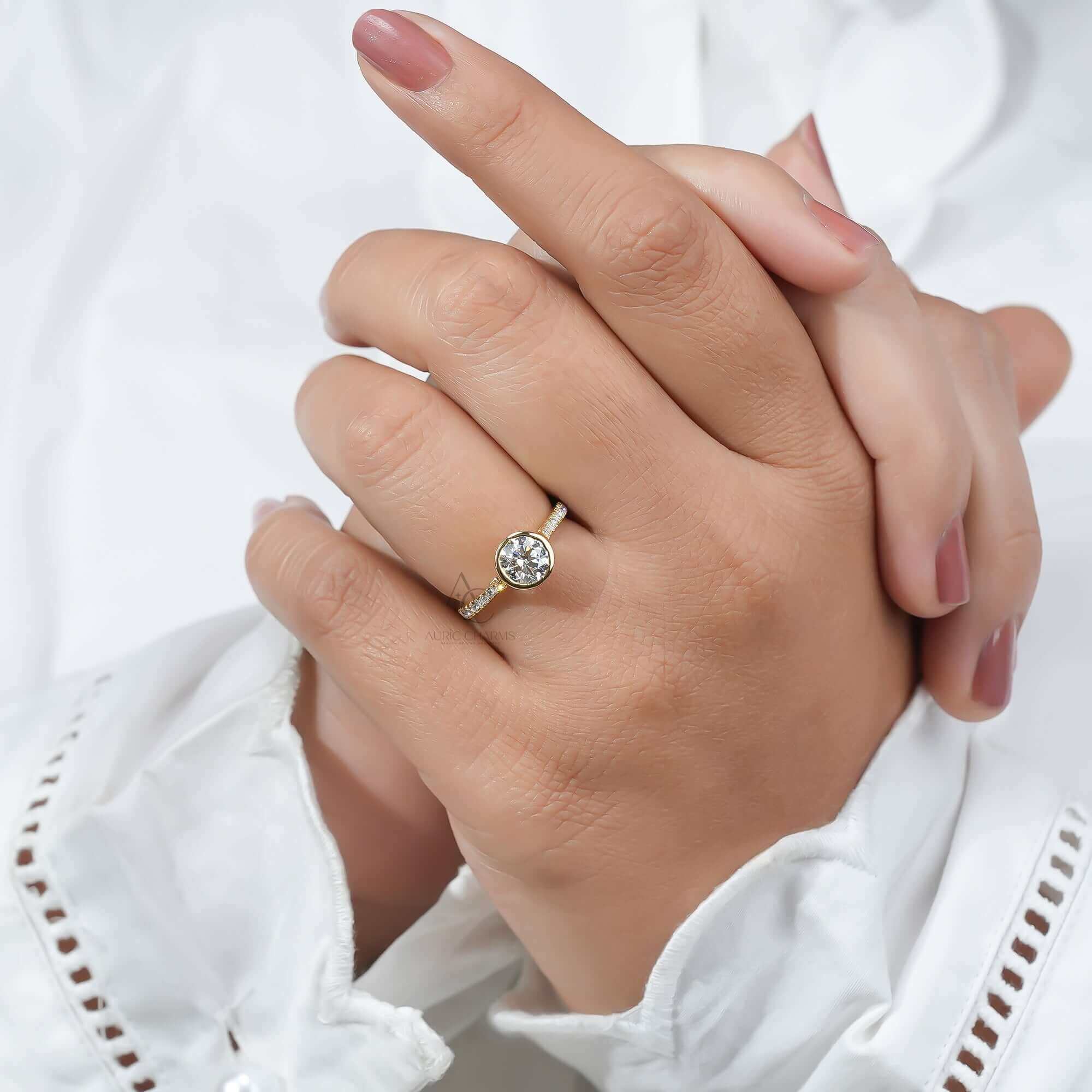 Bezel-set diamond ring on finger showing the design and fit.