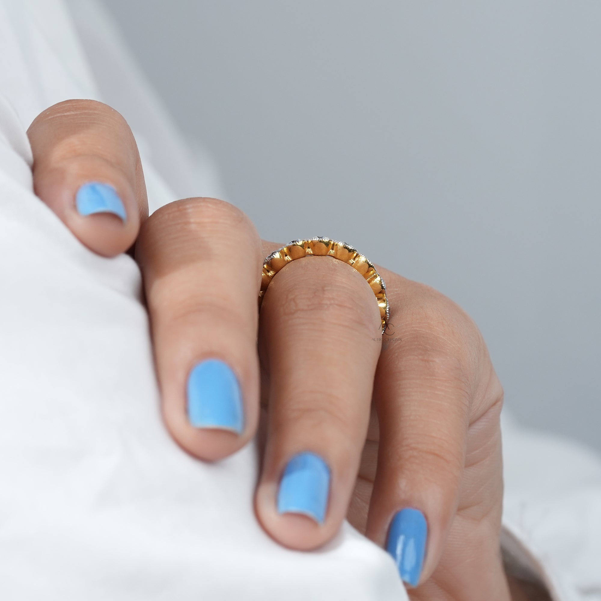 A hand showcasing a luxurious lab-grown diamond half eternity ring, exuding elegance and sustainable beauty.