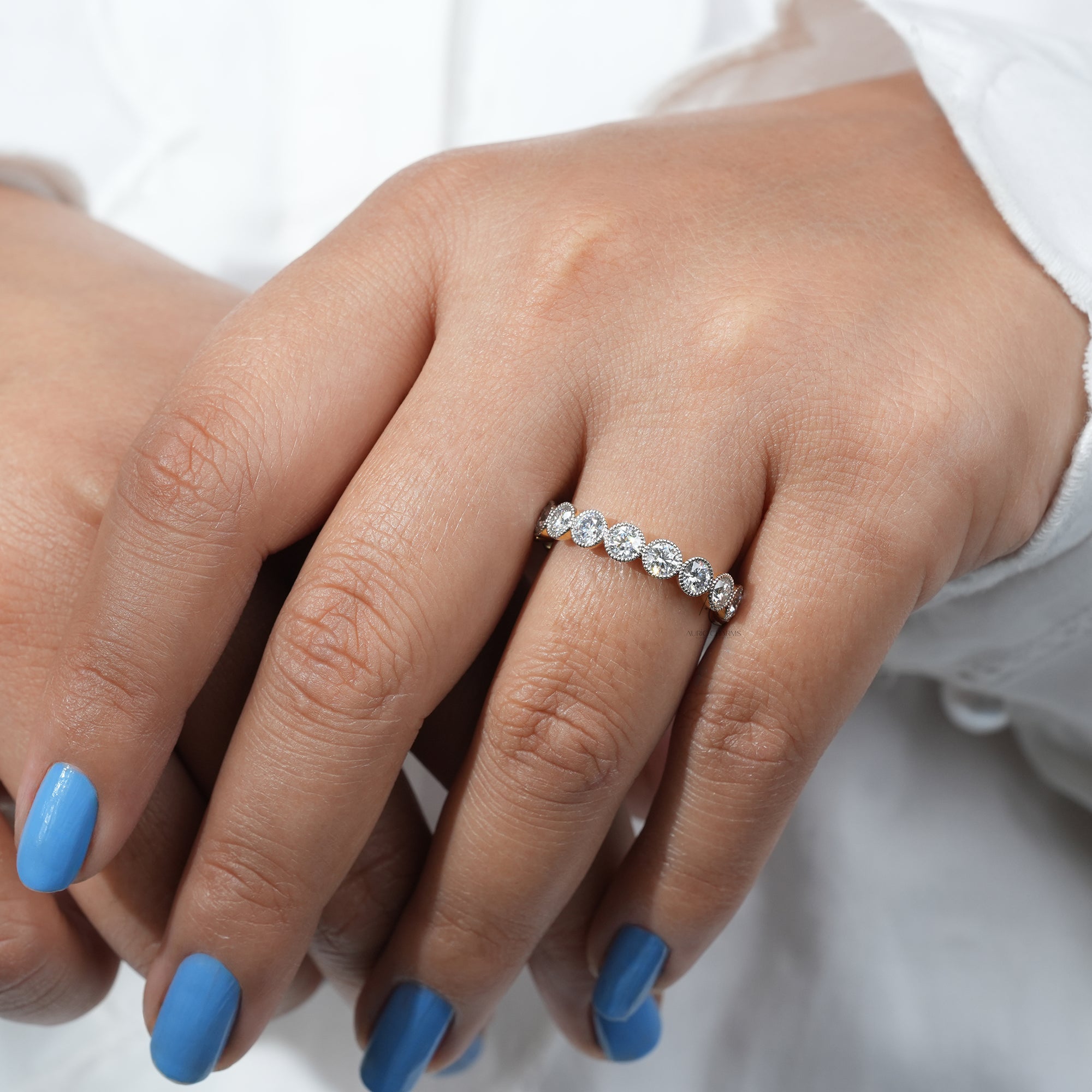 Monroe Round Cut Bold Half Eternity Diamond Ring, featuring lab-grown diamonds, elegantly worn on a hand with blue nails.