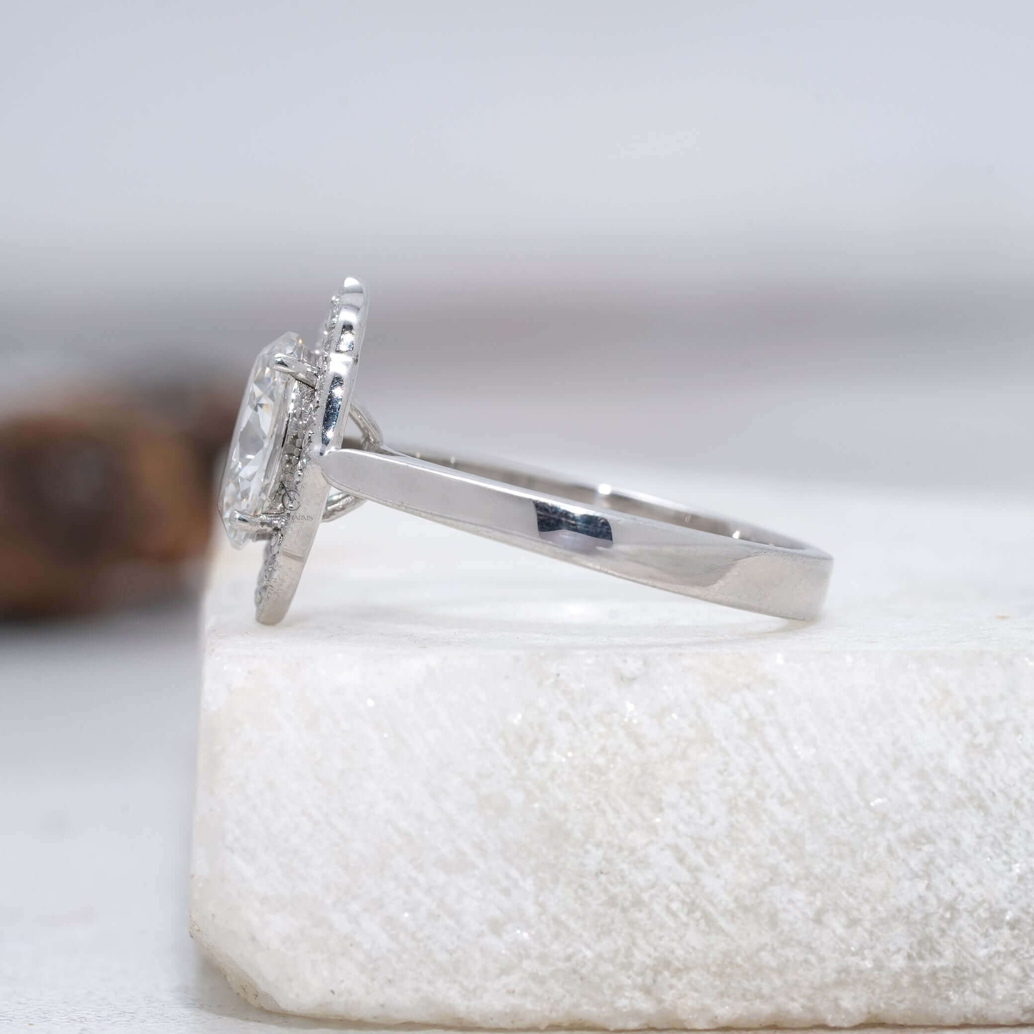 Elegant oval diamond ring featuring halo detailing and modern design.