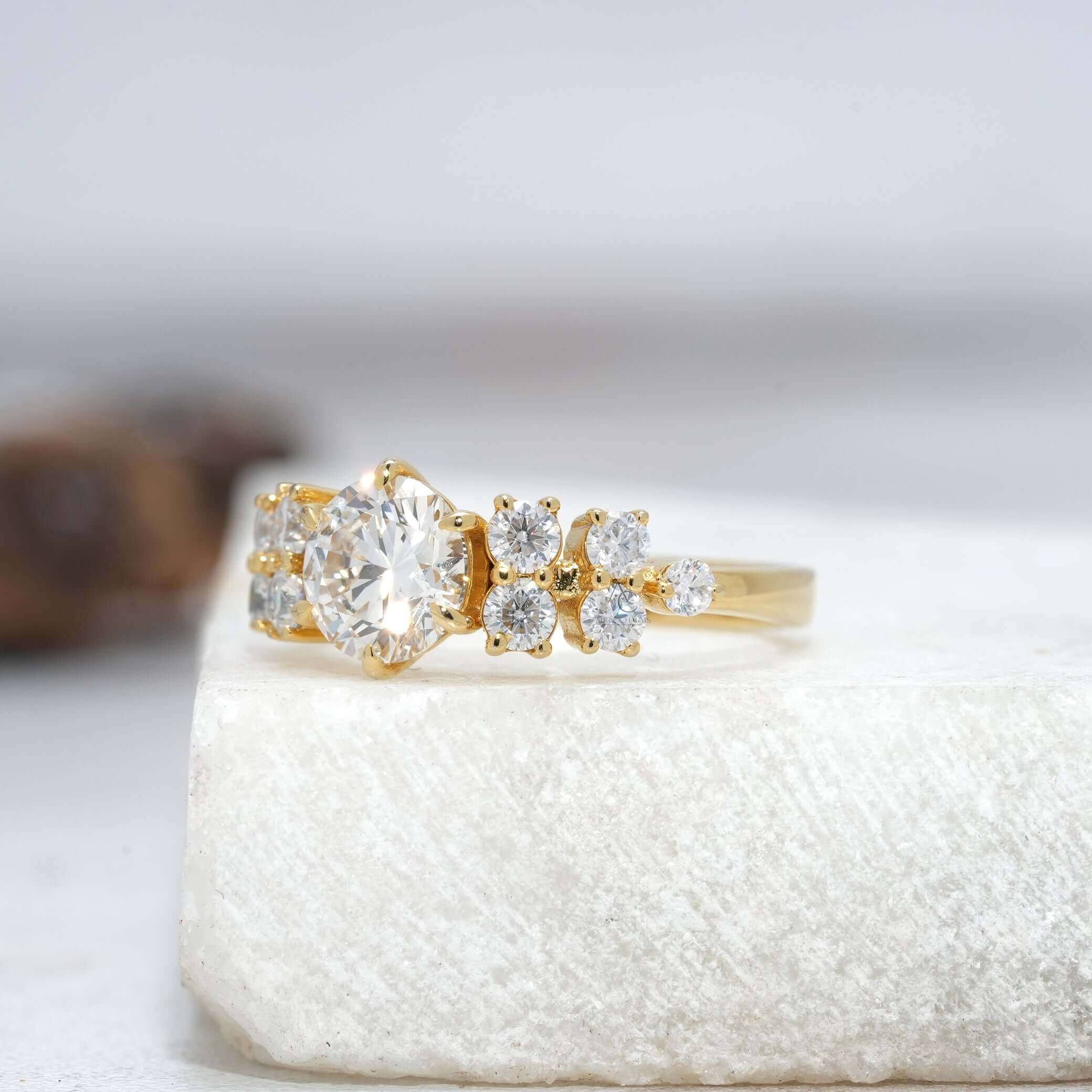 Side view of a round brilliant diamond solitaire ring, showcasing sparkling side diamond accents.