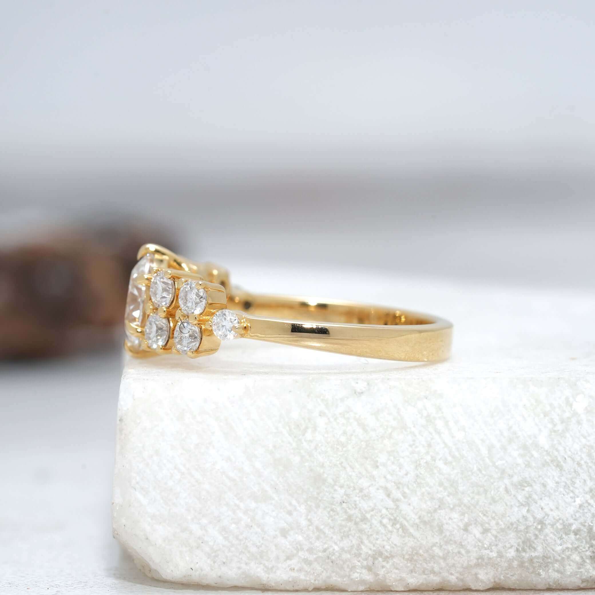 Side view of round diamond solitaire ring with intricate detailing and accent diamonds on the band.