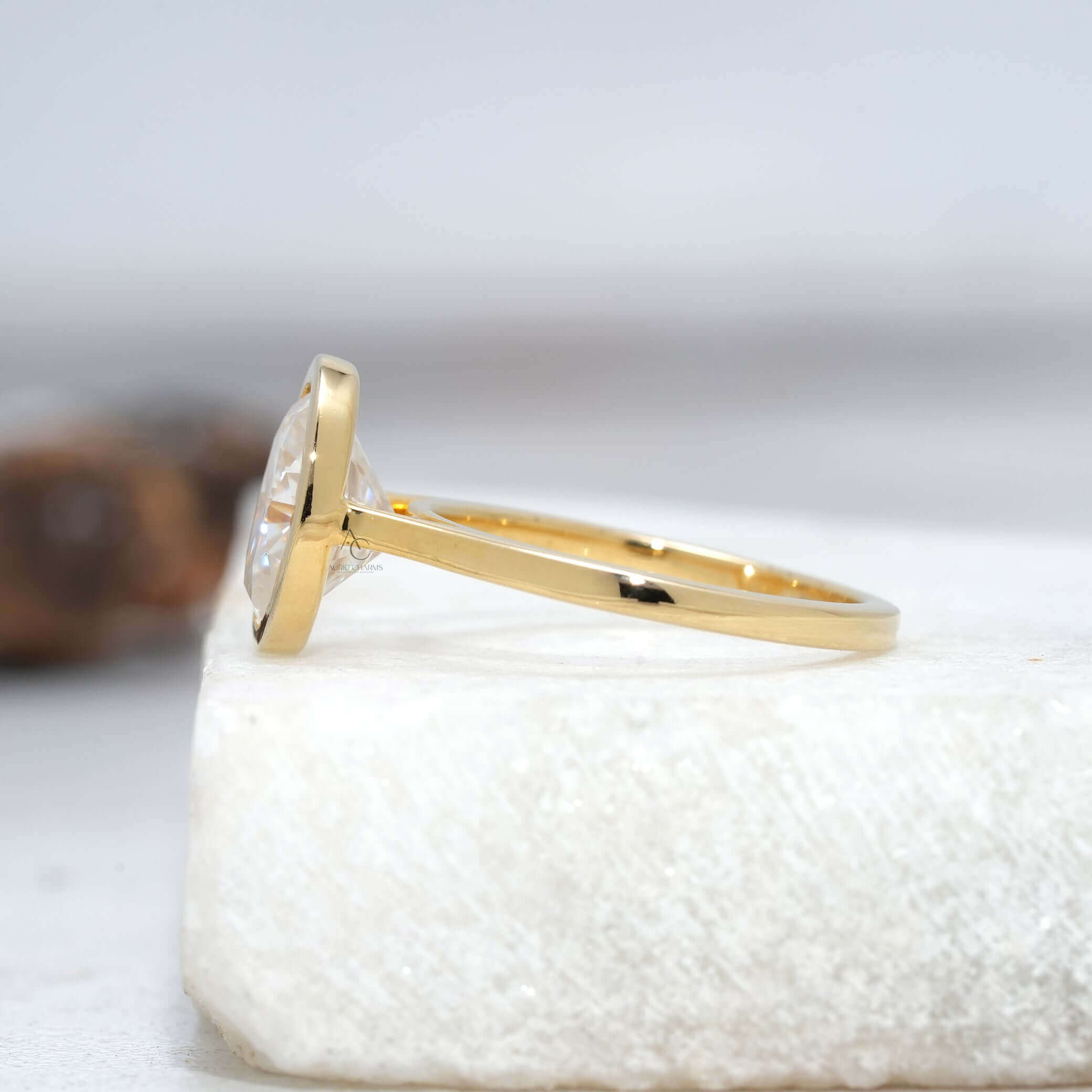 Solitaire oval ring viewed from side angle showing thin band.