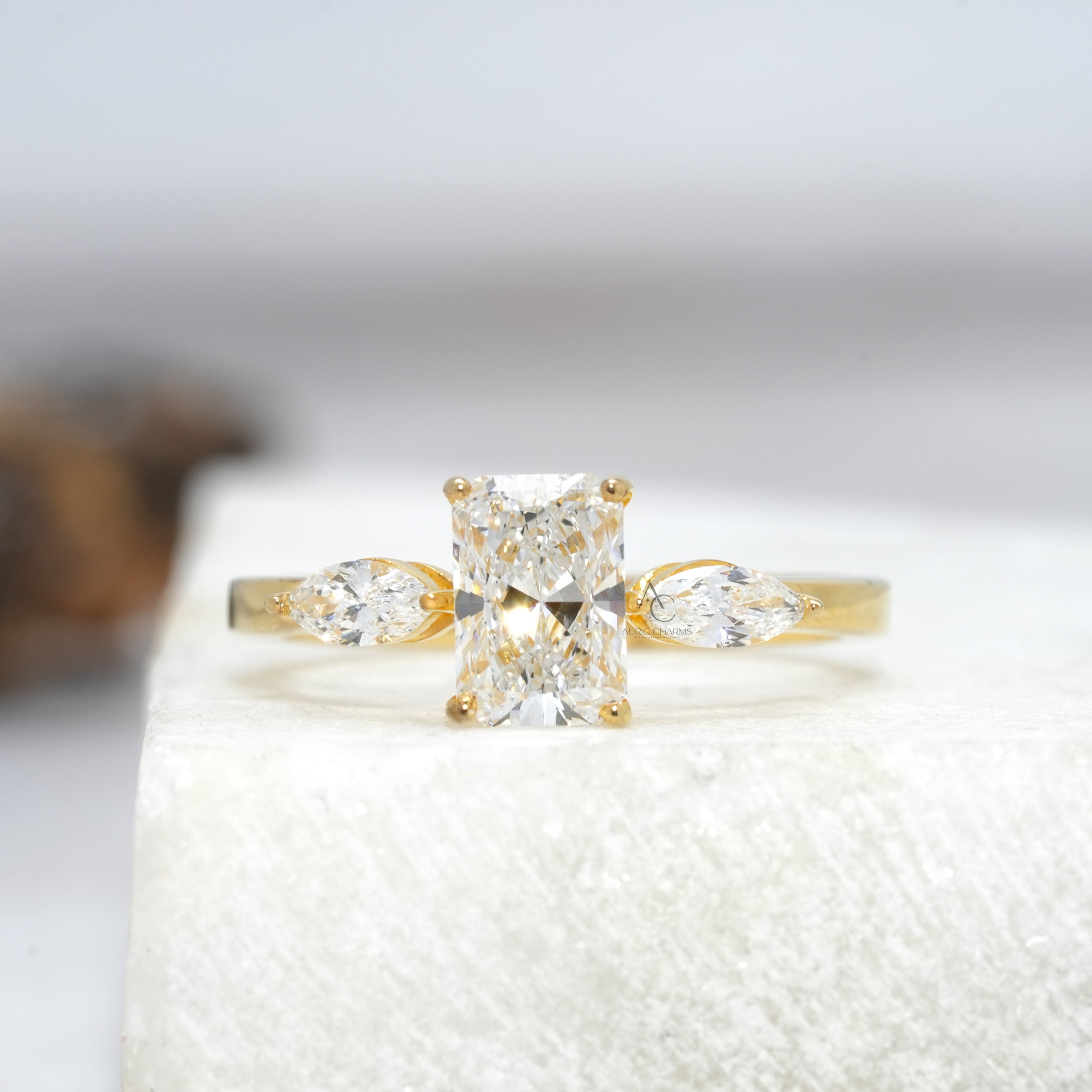 Radiant cut lab-grown diamond ring with marquise side stones in a sleek platinum band - perfect for sustainable luxury engagements.