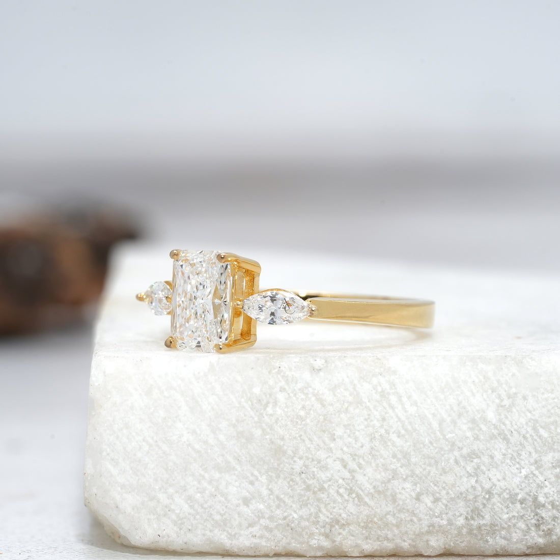 Side profile of a radiant cut lab-grown diamond engagement ring featuring marquise side stones, designed for modern brides.