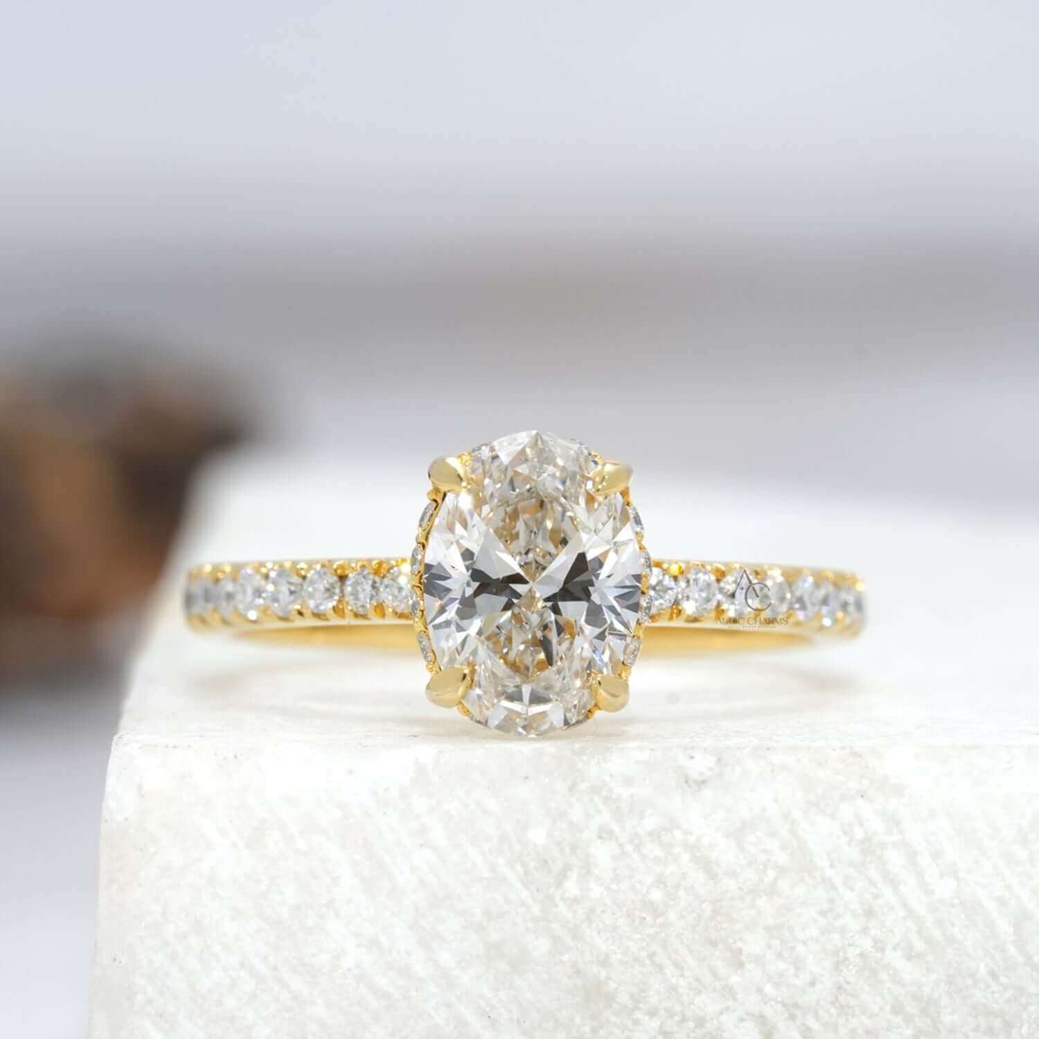 Oval lab-grown diamond solitaire ring with delicate pave band, elegant and timeless design.