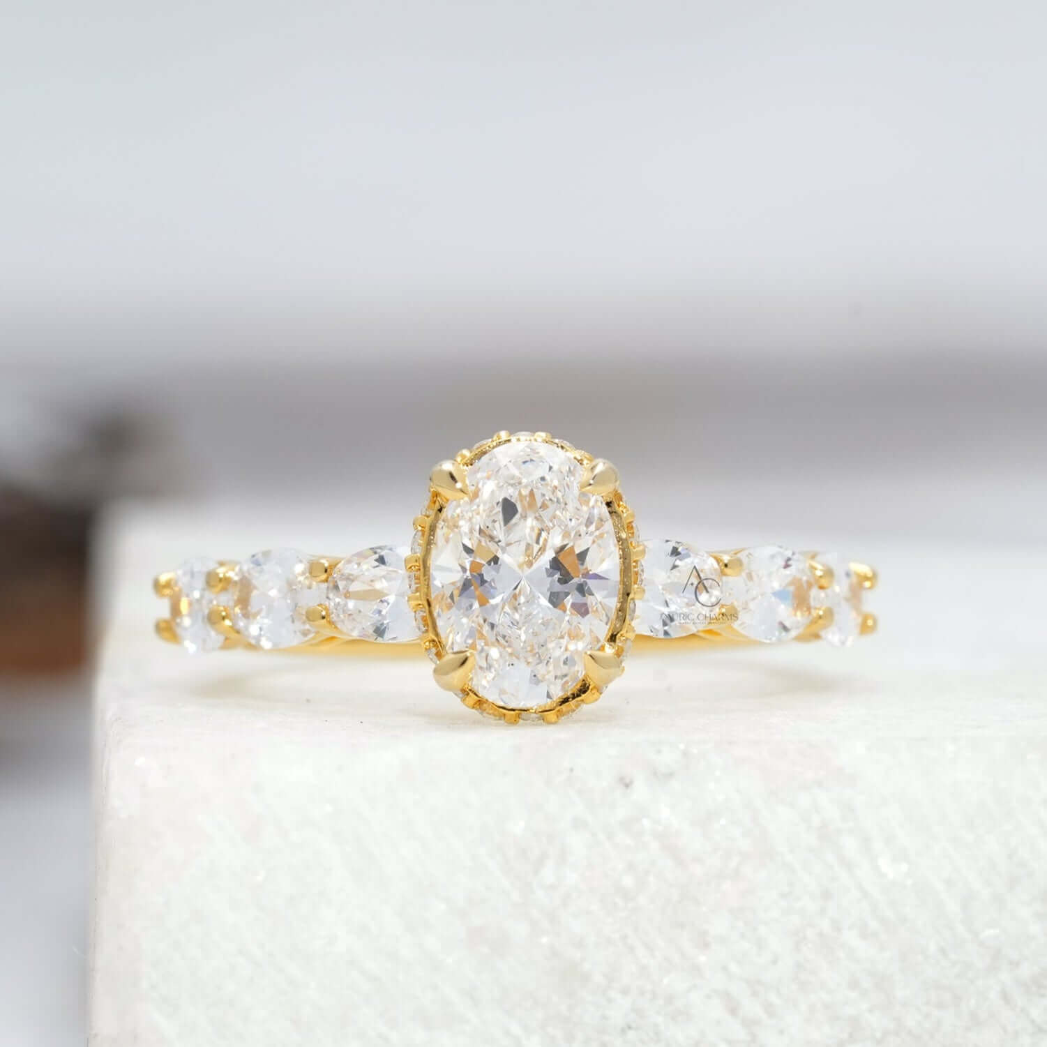 Oval cut diamond ring with side stones and sleek band, front view.