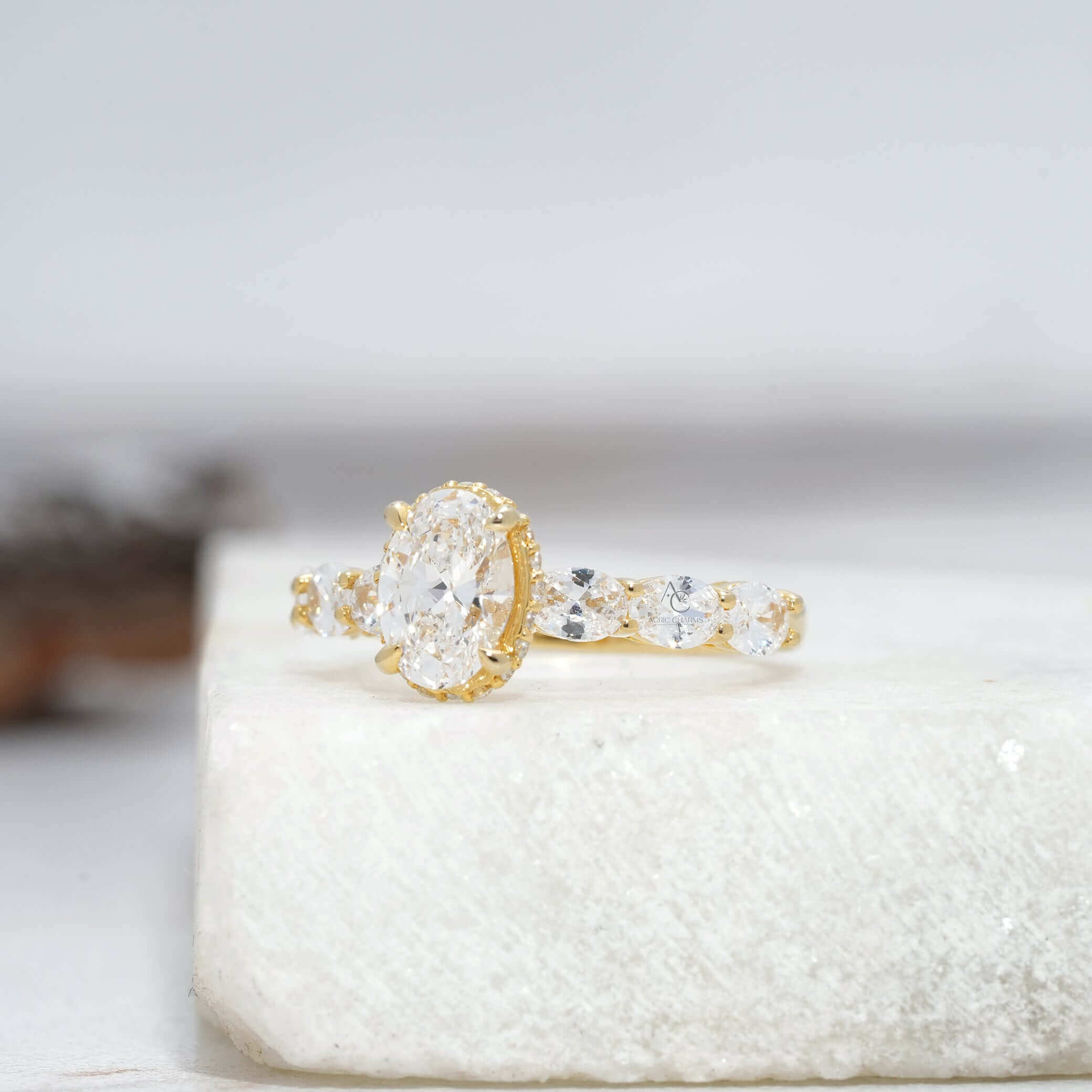 Side view of oval diamond ring with accented stones and polished band.