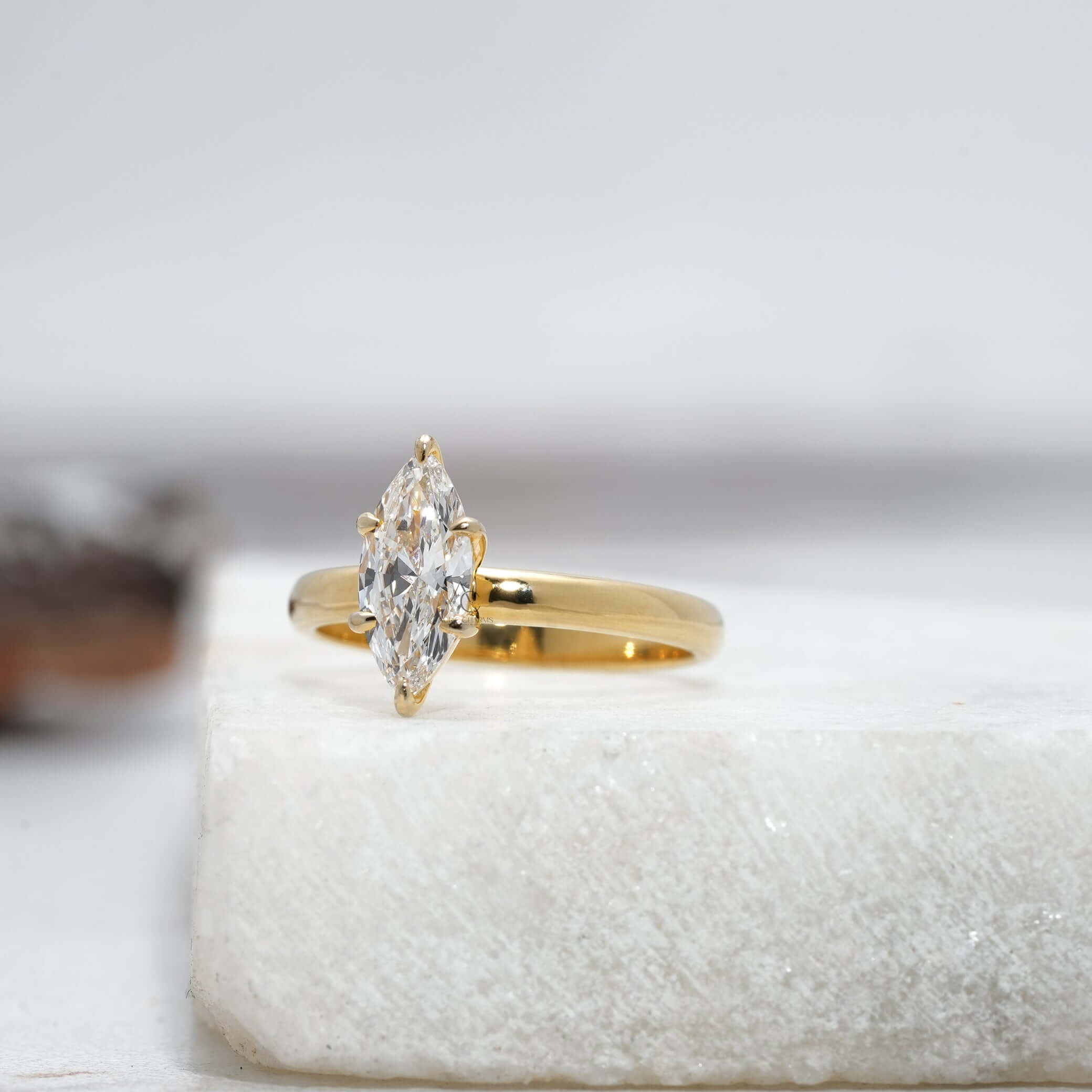 Angled view showcasing the elegance of the marquise-cut diamond solitaire ring with a reflective polished band.