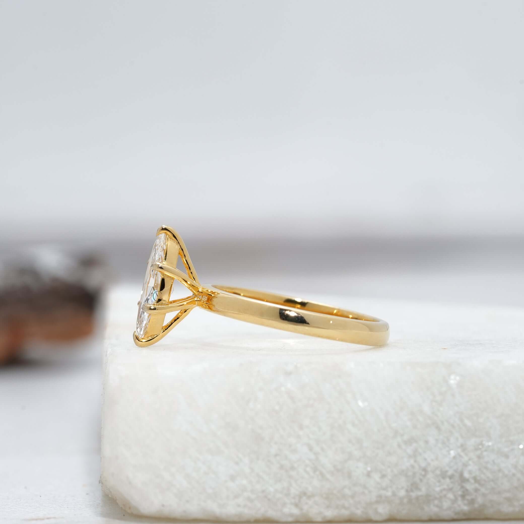 side view of the marquise-cut diamond solitaire ring highlighting the intricate prong setting and central stone brilliance.