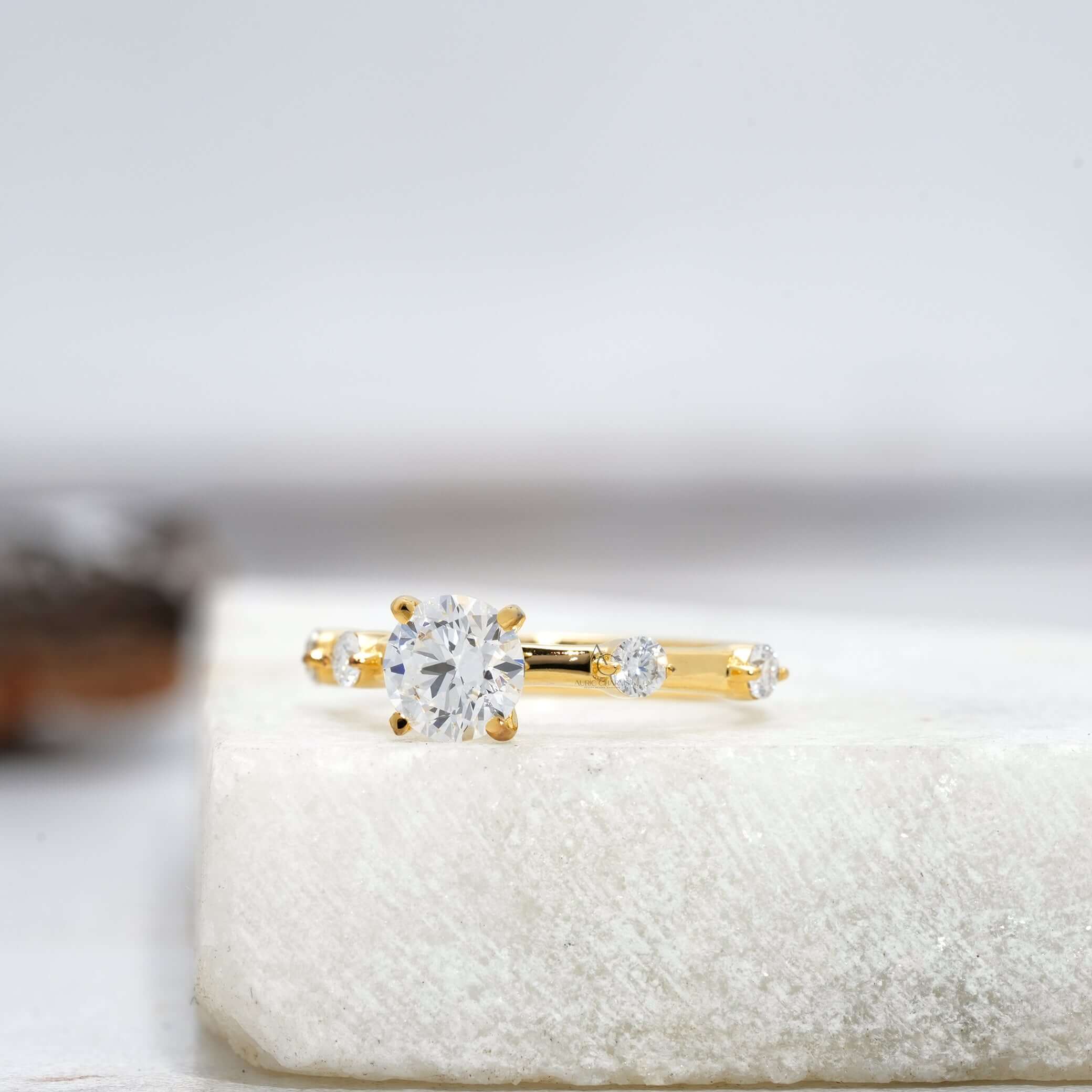 Angled view of a round-cut diamond ring with a polished white gold band.