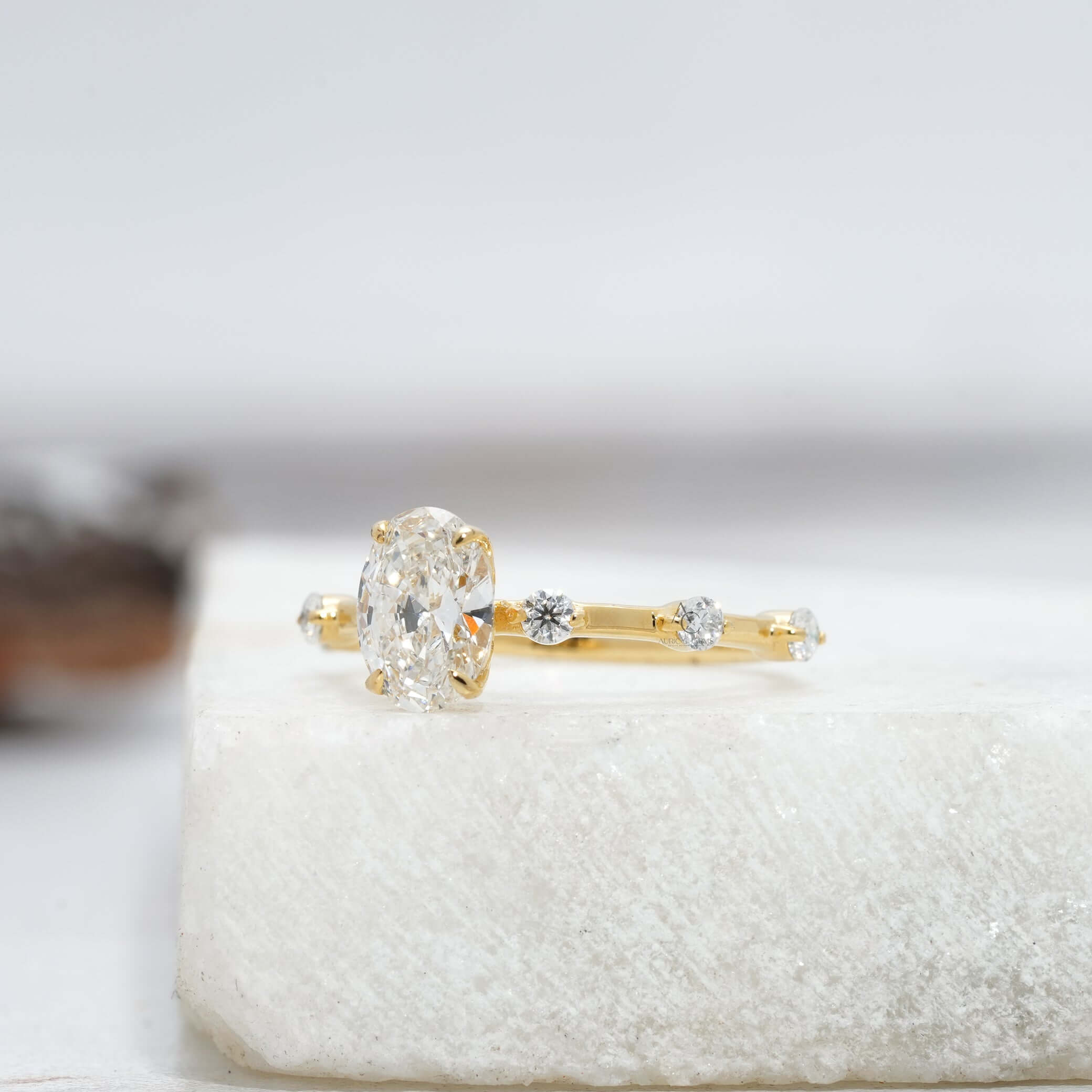 Side profile of an oval-cut diamond engagement ring showcasing its intricate design.
