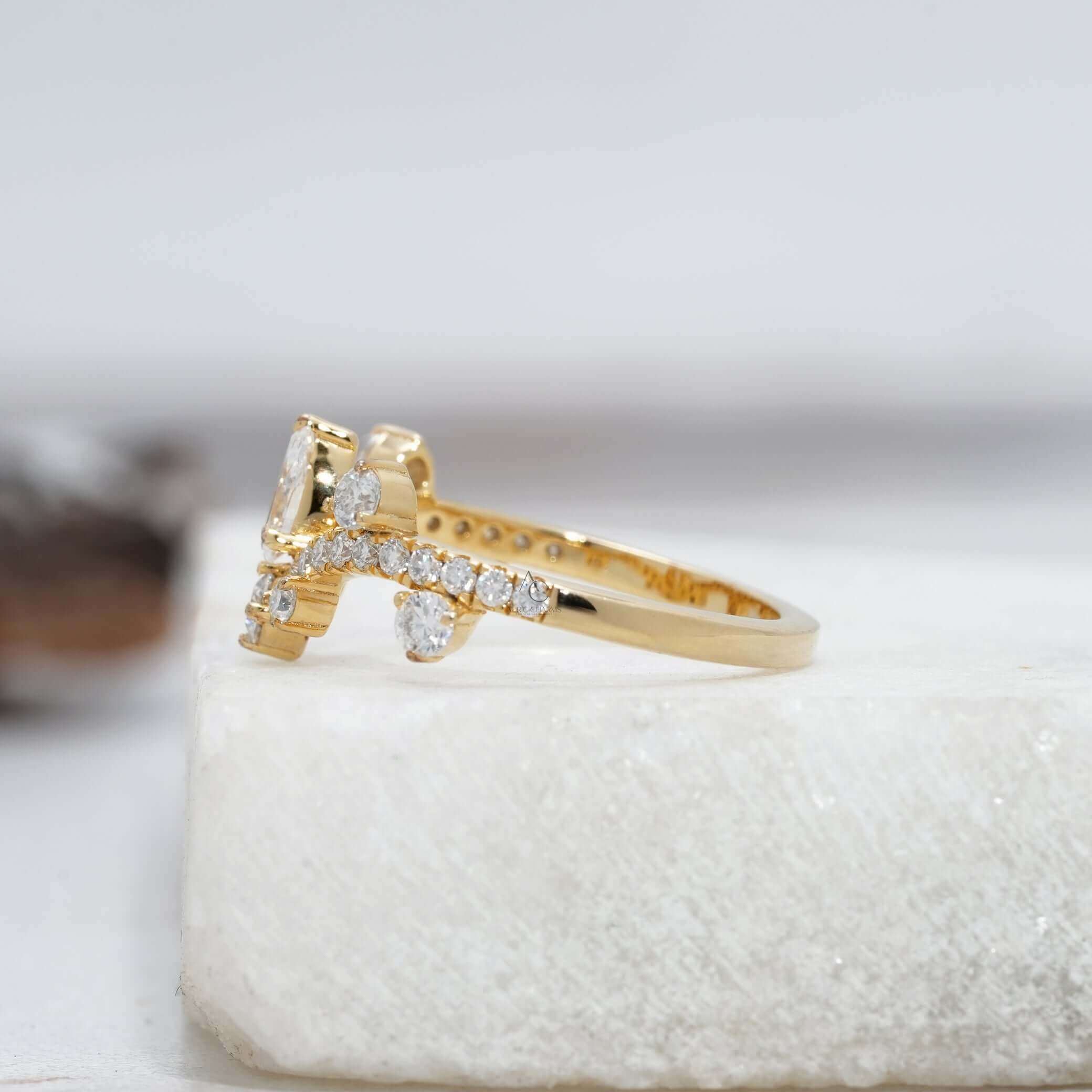 Angle view of a diamond crown ring highlighting its pear-shaped diamond centerpiece.