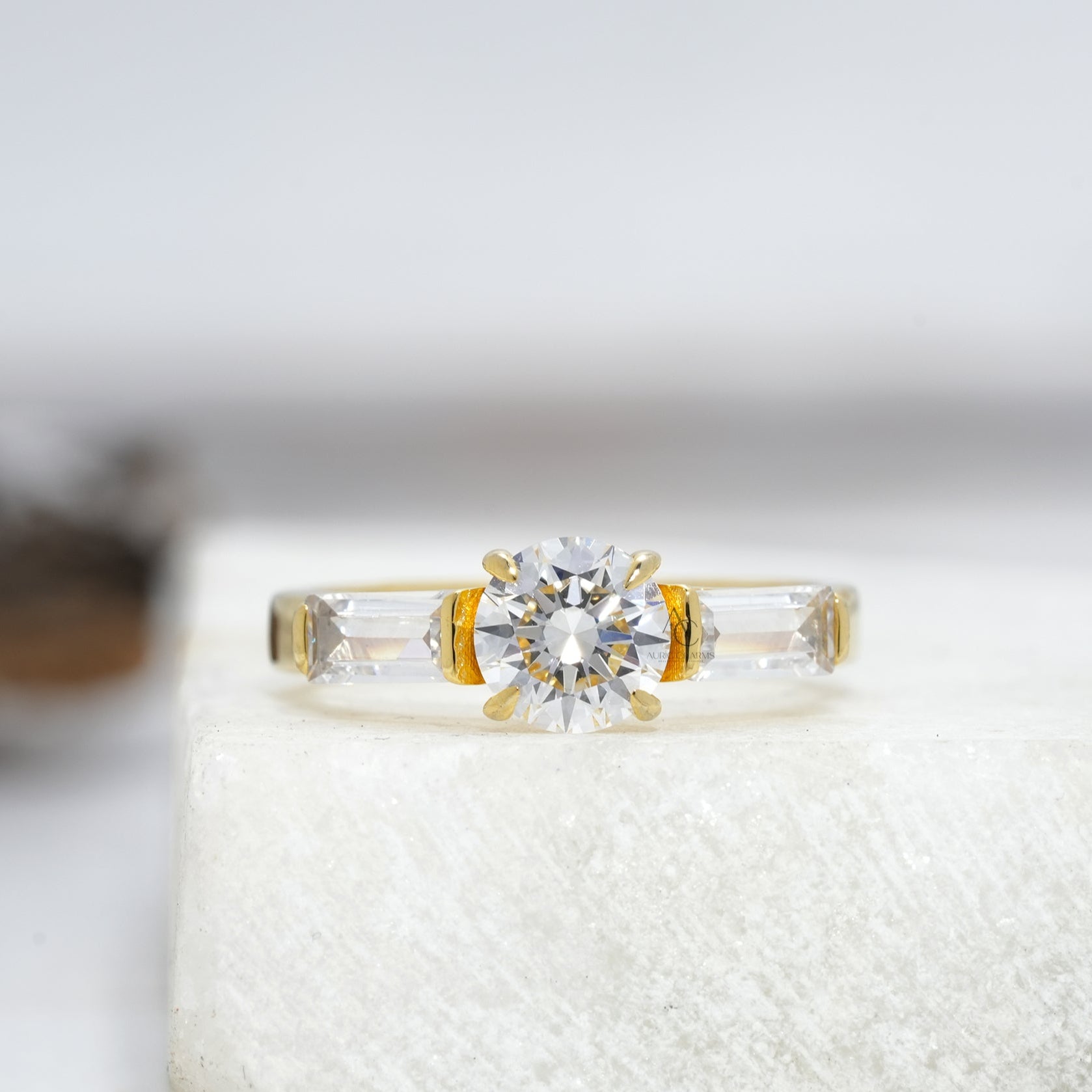 Classic round-cut diamond engagement ring with baguette side stones set in platinum, reflecting timeless elegance.
