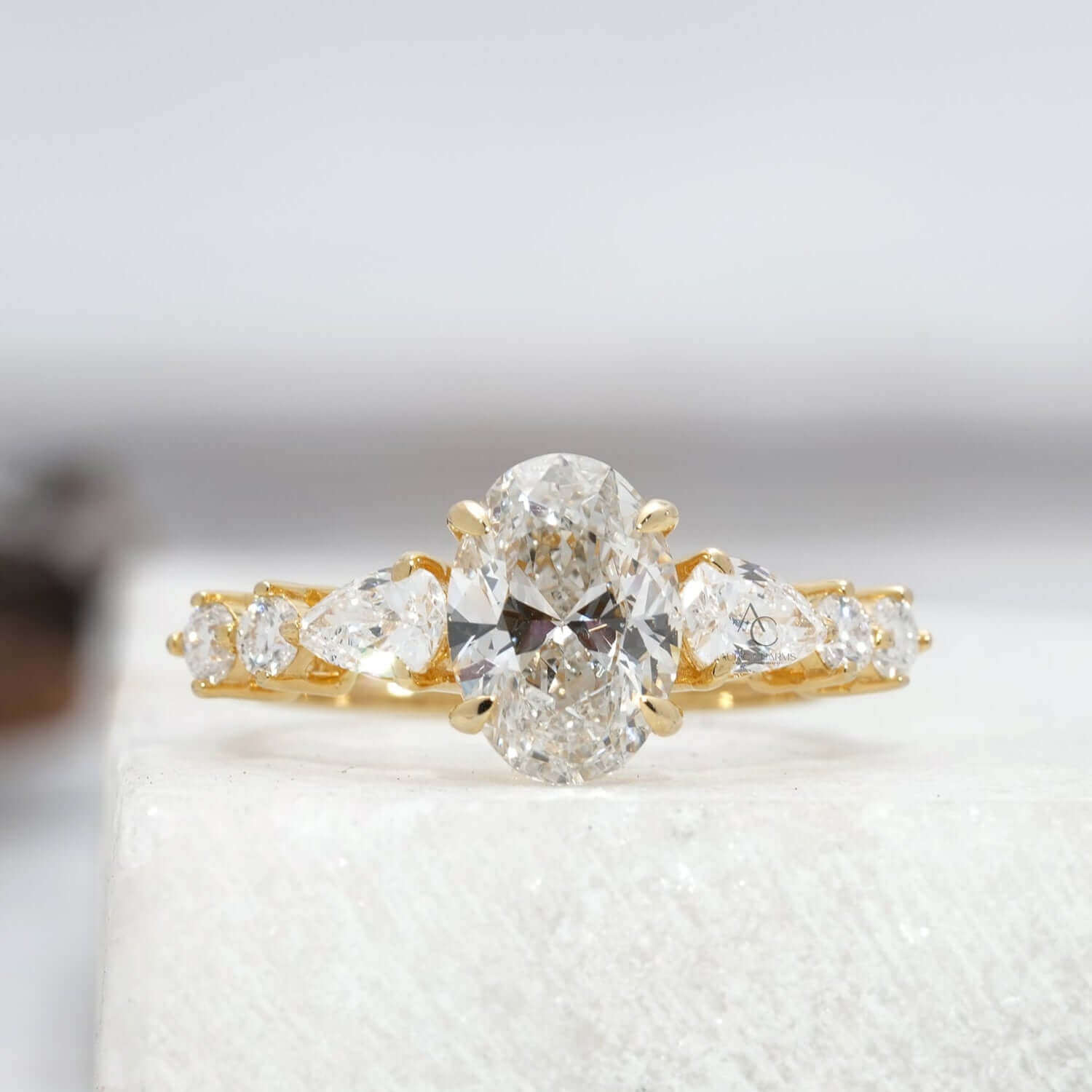 Oval lab-grown diamond engagement ring with brilliant side stones in a platinum band.