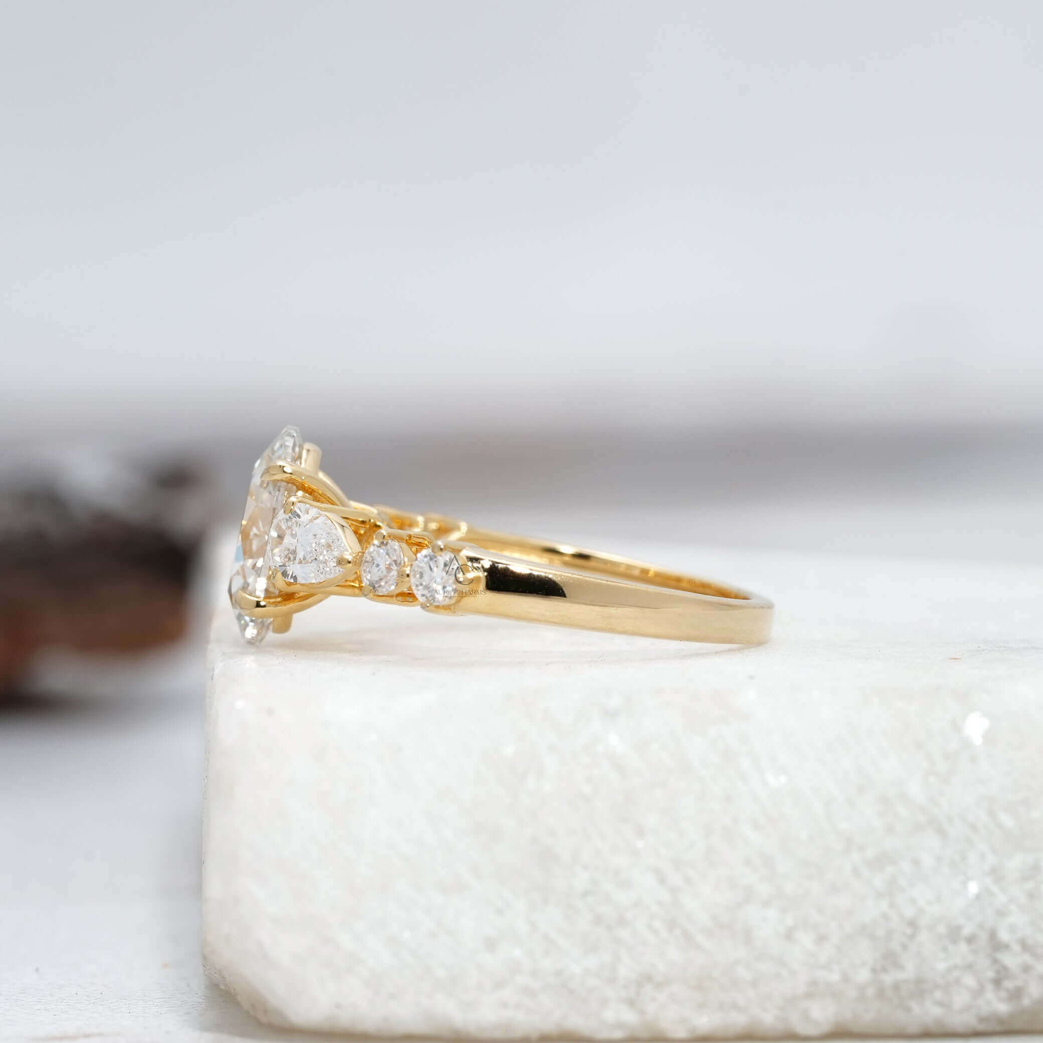 Elegant oval diamond ring with intricate details and sparkling side accents in white gold.