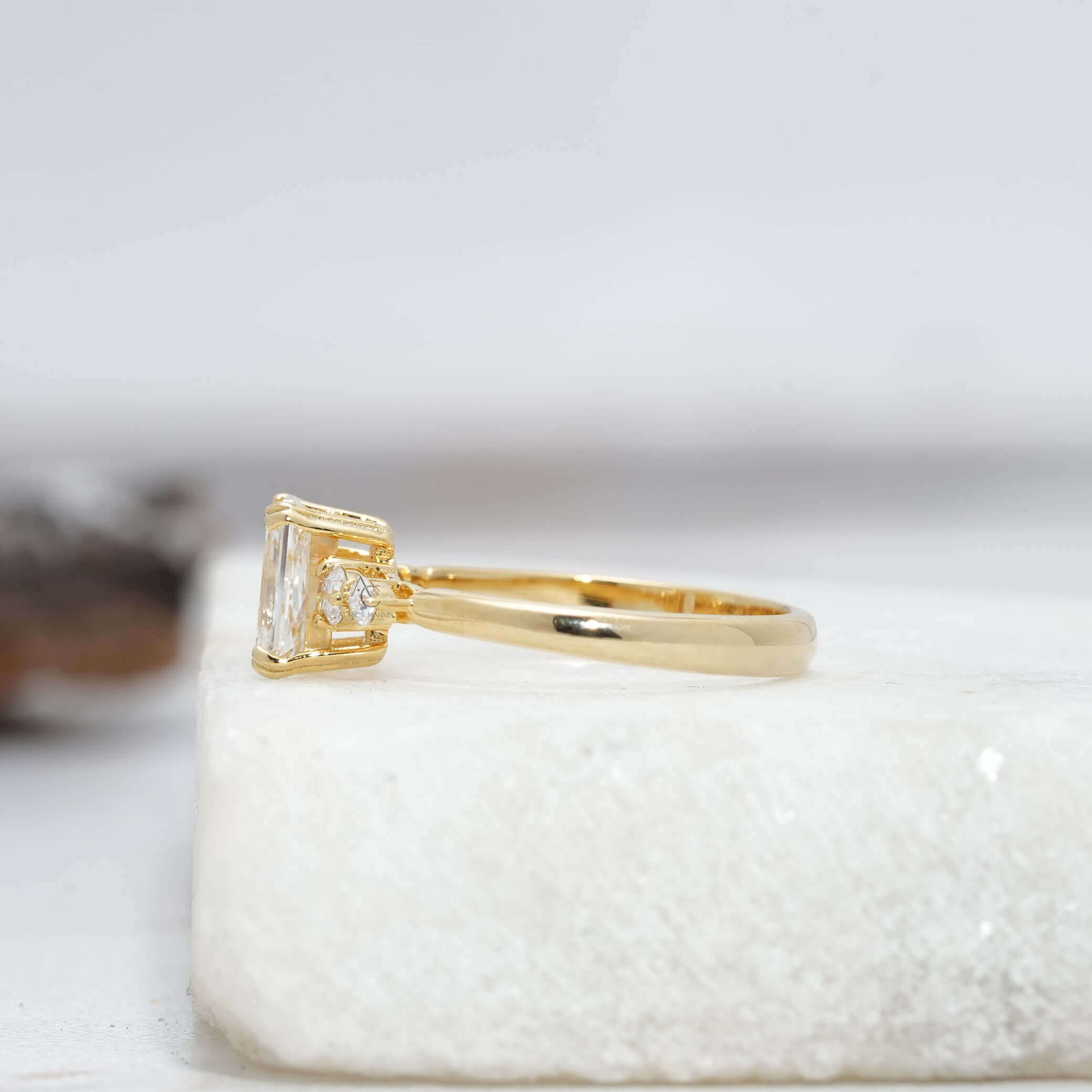 Side view of a radiant-cut diamond ring showcasing the intricate white gold setting.