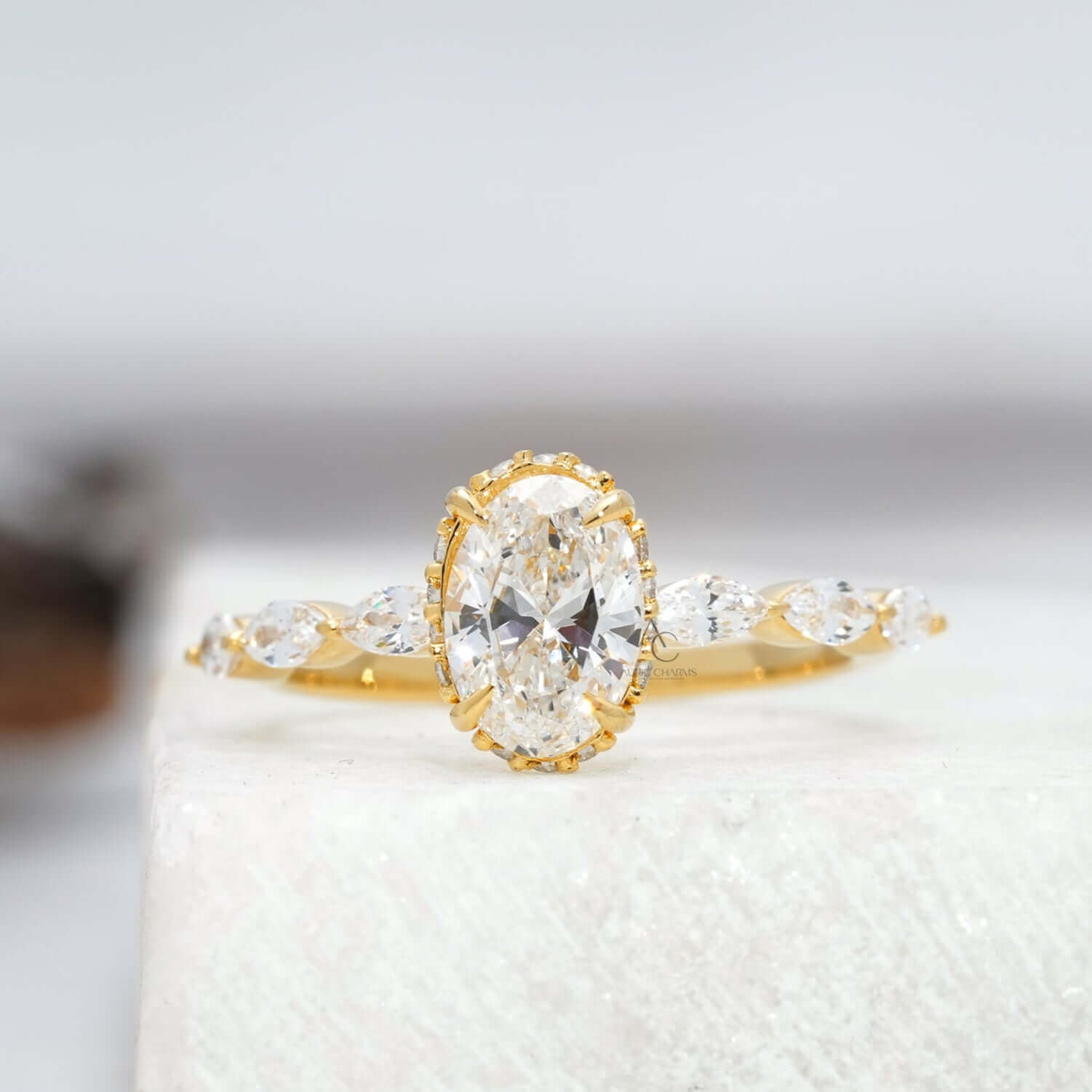 Close-up view of oval diamond engagement ring with marquise side stones.