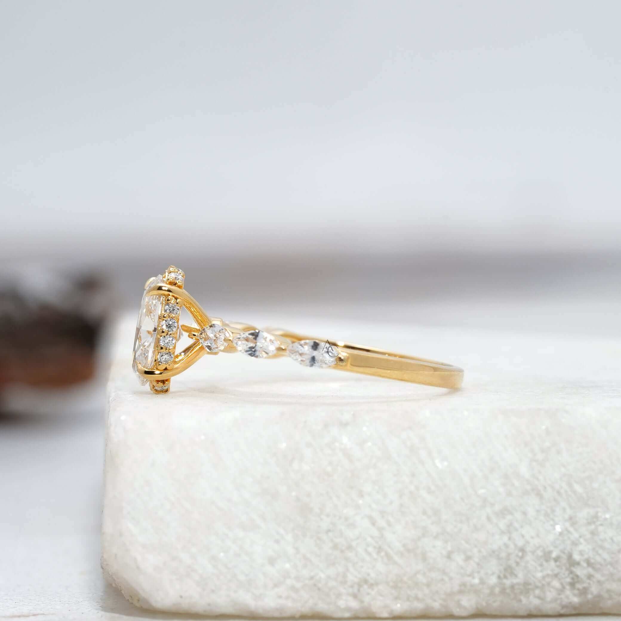 Side view of oval diamond ring with marquise band and gallery details.