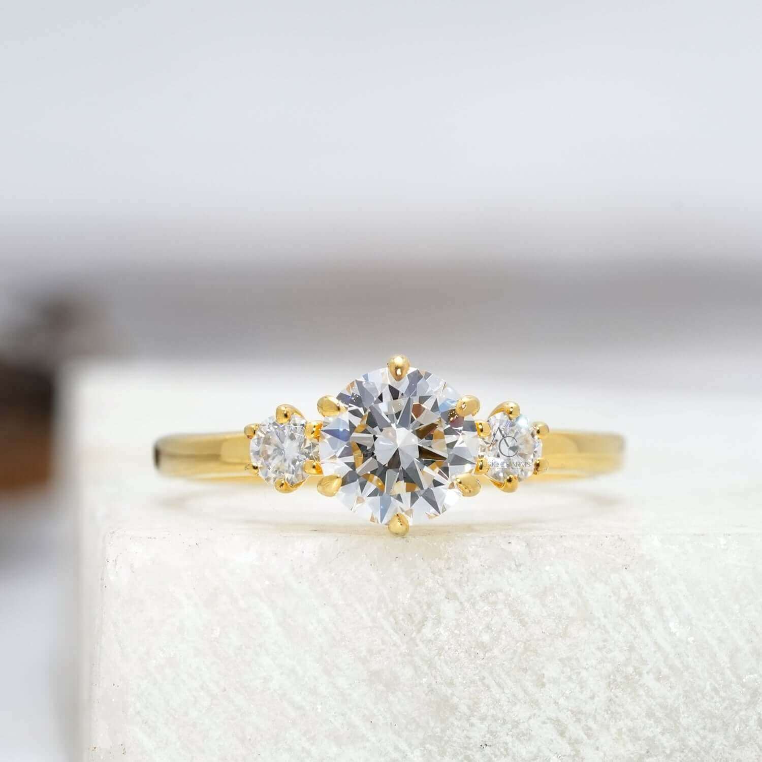 Elegant three-stone engagement ring with round lab-grown diamonds.