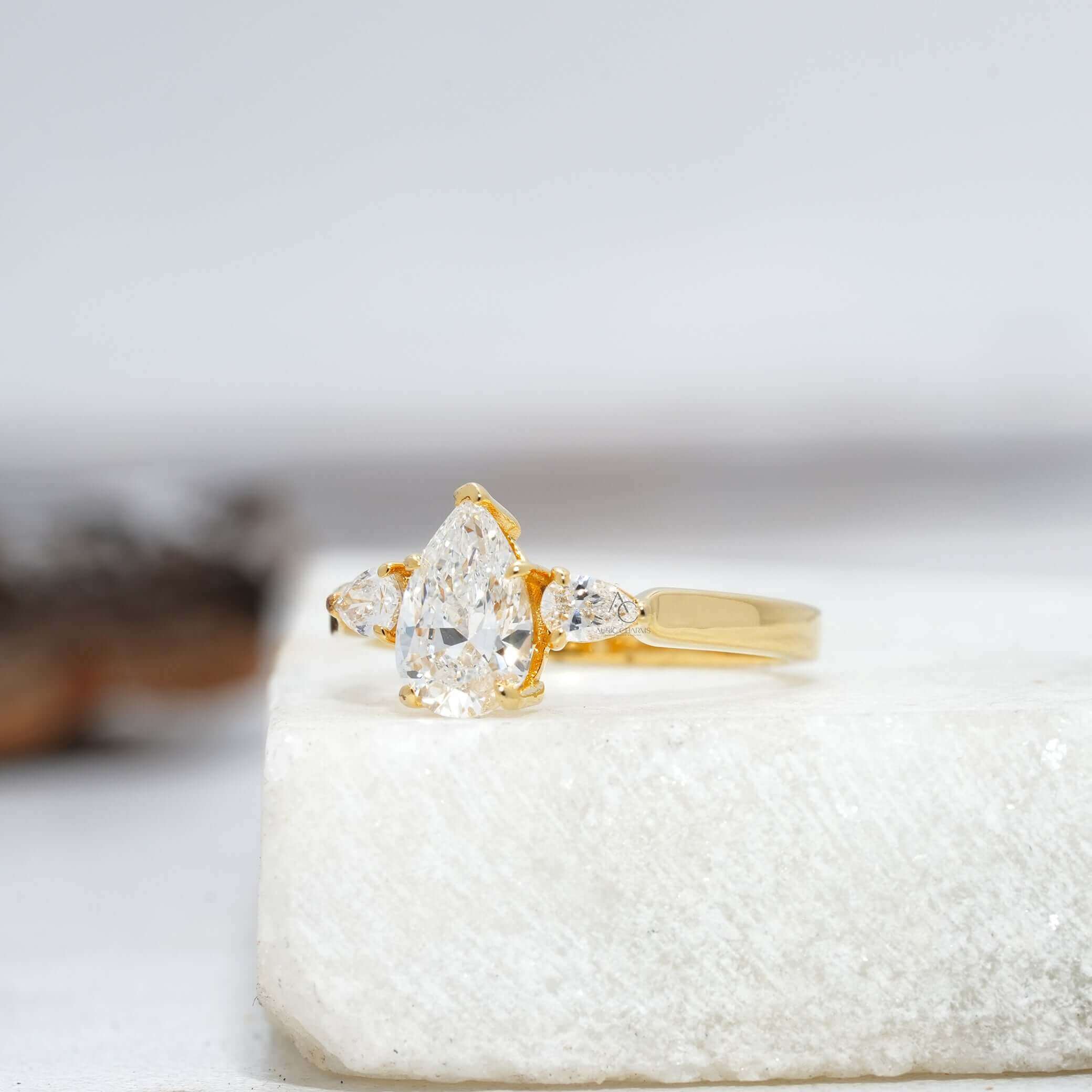 Side view of a stunning pear-cut diamond ring with platinum band, showcasing intricate detailing.