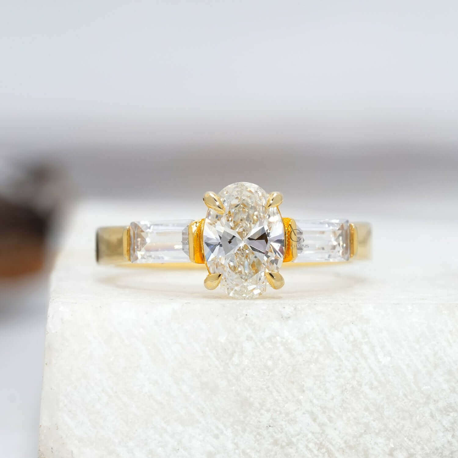 Oval diamond ring with tapered baguettes, showcasing timeless elegance and precision cut.