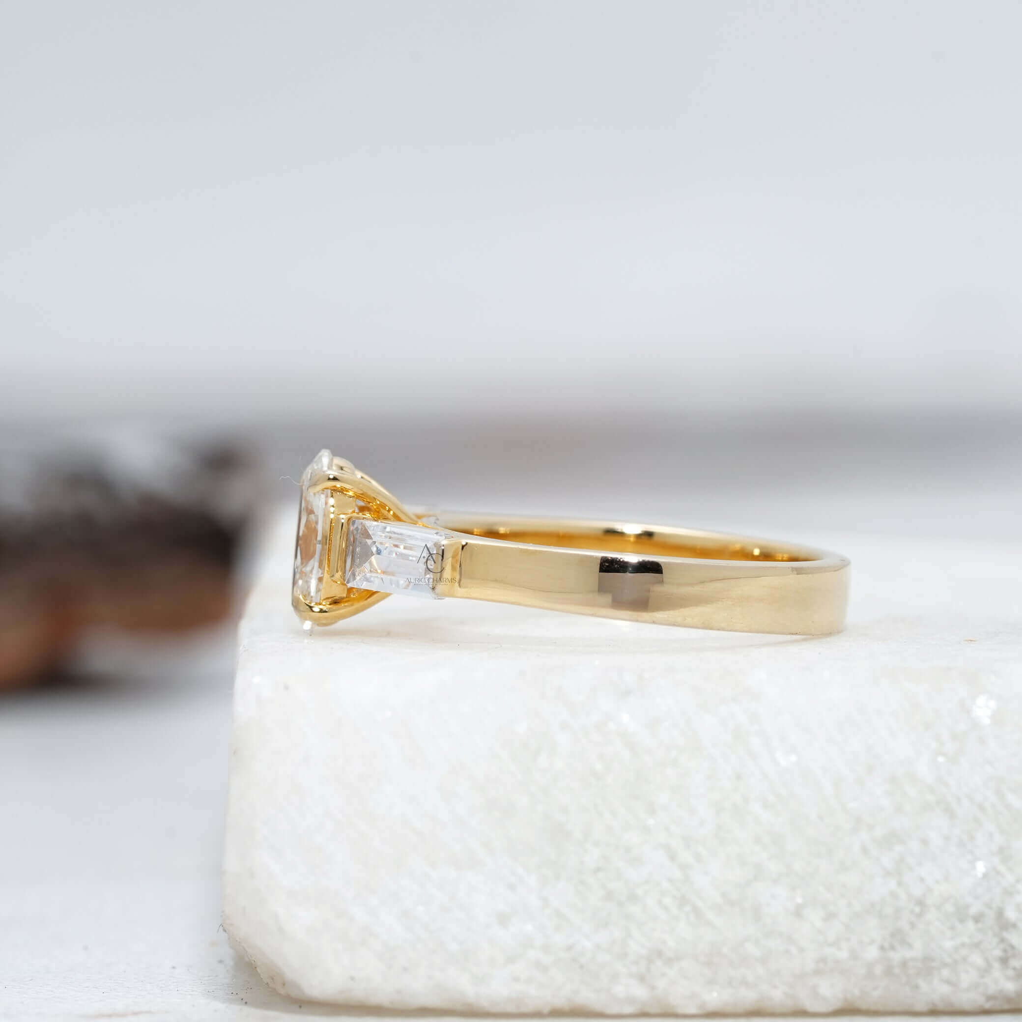 Angled view of an oval diamond ring with baguettes, revealing intricate craftsmanship details.