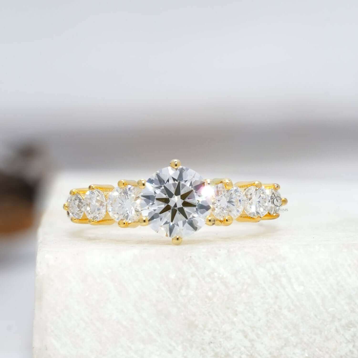 Brilliant round-cut diamond ring with dazzling side stones on a reflective surface.
