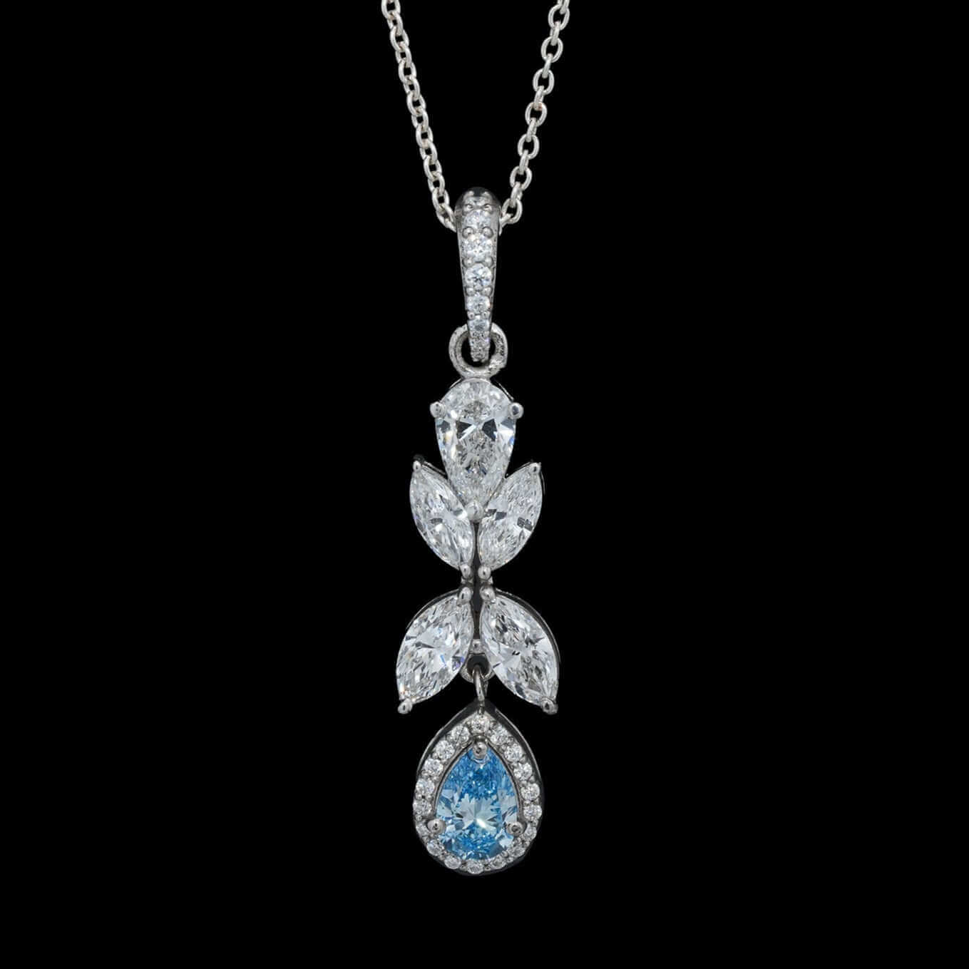White gold pendant necklace featuring marquise and pear-cut lab-grown diamonds with blue sapphire