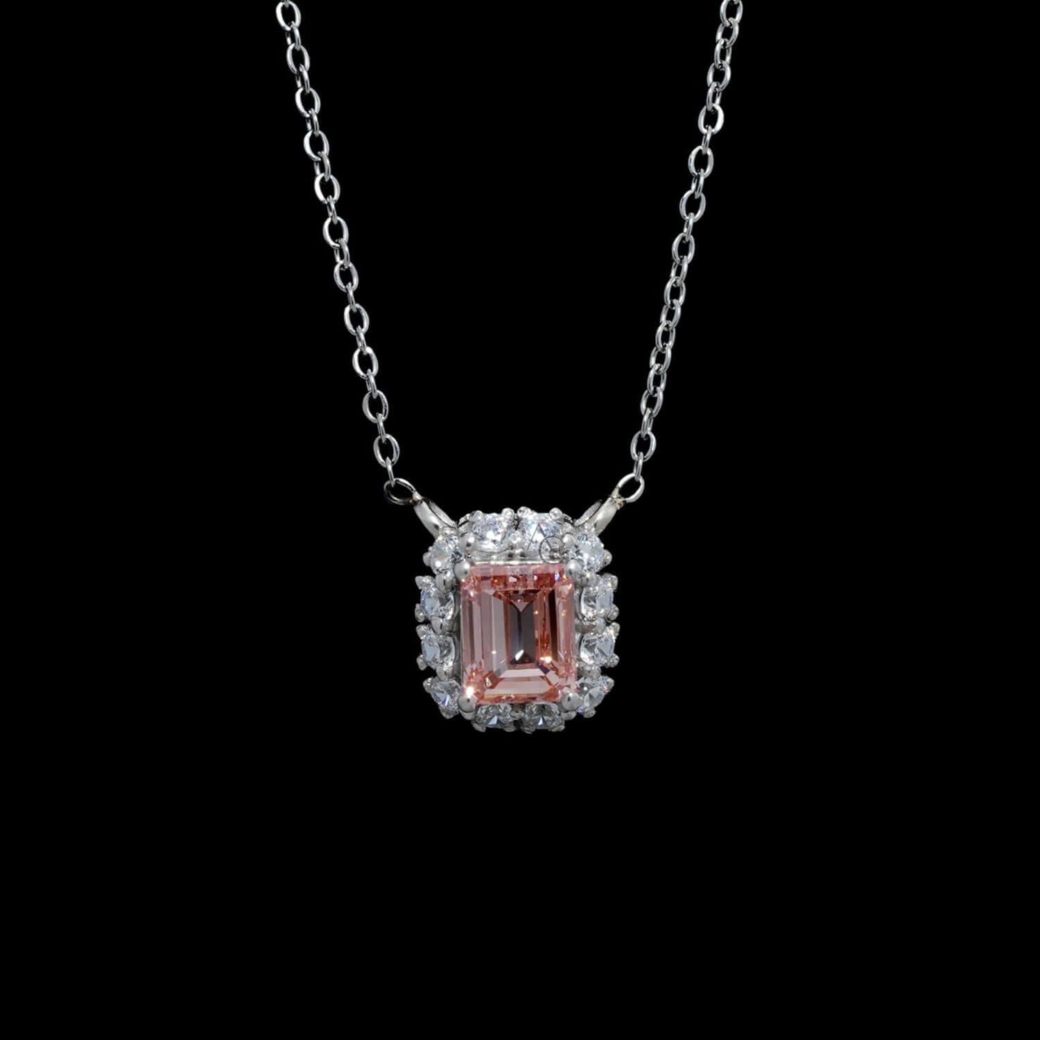 Luxury Fancy Pink Emerald Cut Lab Grown Diamond Halo Pendant Necklace worn on neck, surrounded by brilliant round diamonds.