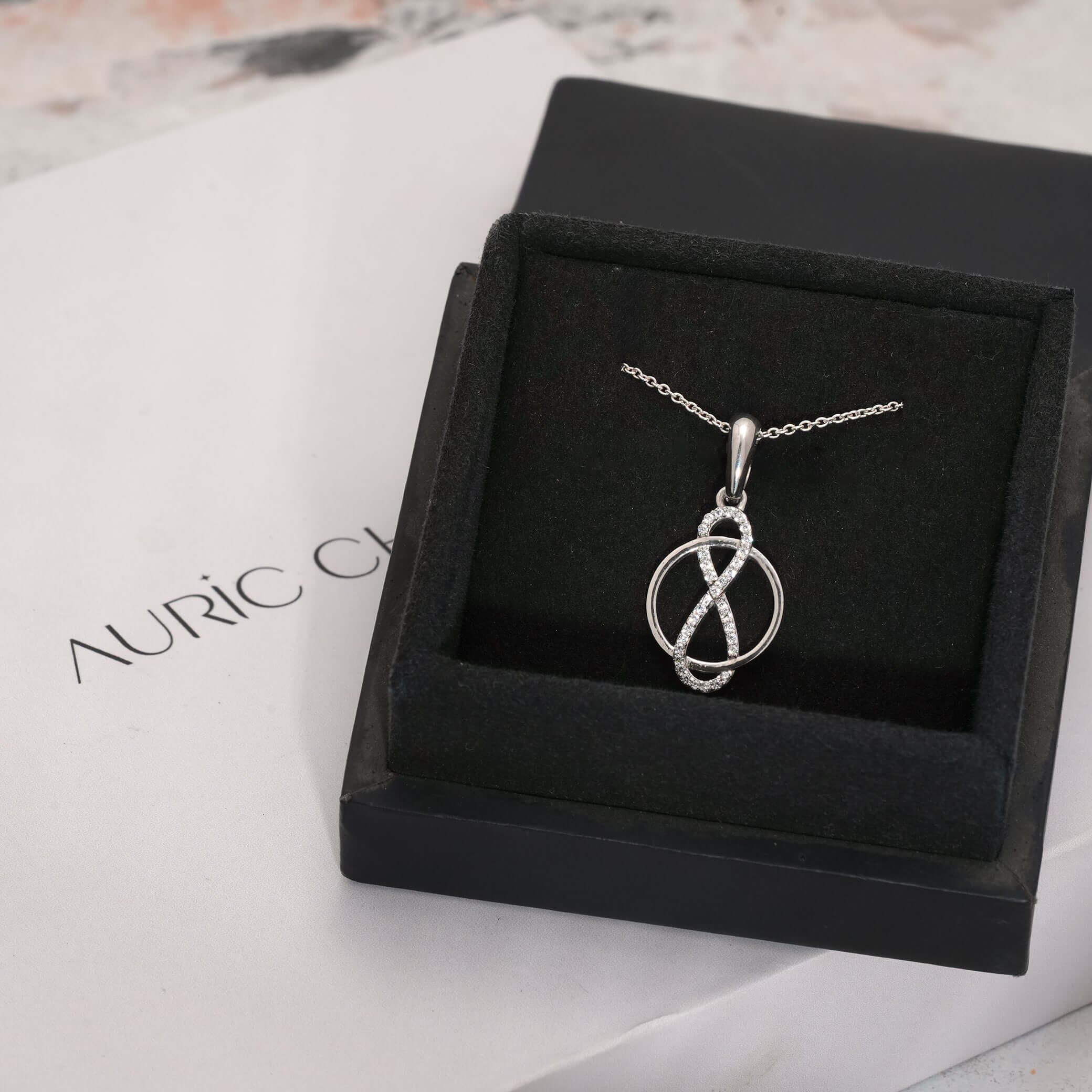 Elegant infinity circle pendant with lab-grown diamonds, displayed in a luxurious box, perfect as an ethical engagement gift.