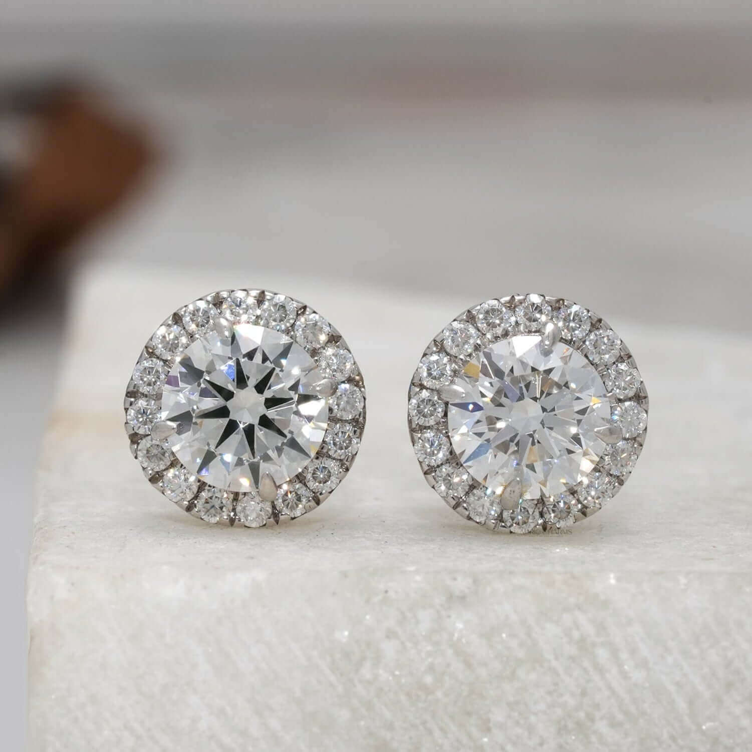 Front view of round brilliant halo diamond stud earrings in white gold, lab-grown diamonds.