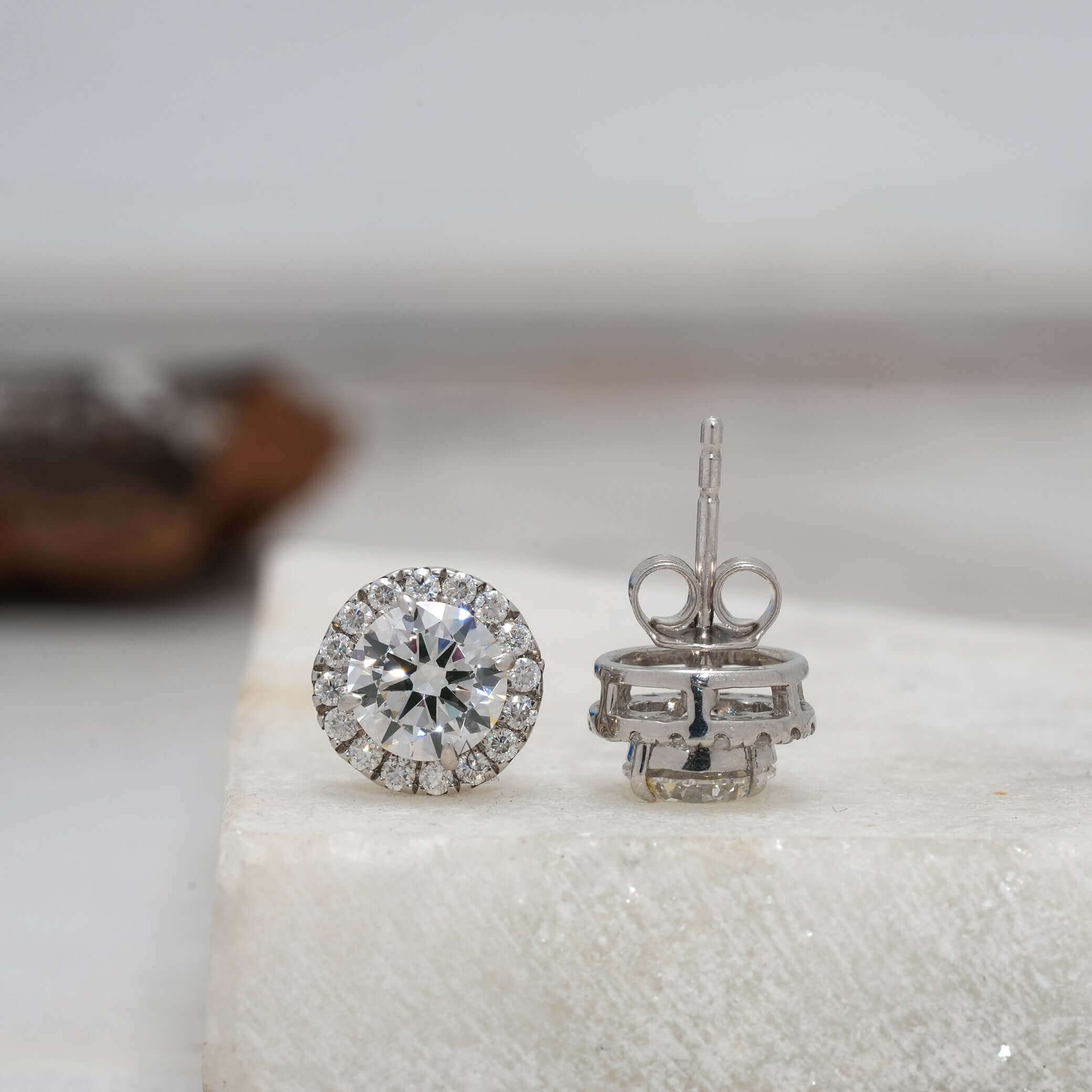Back view of round diamond halo earrings with post and butterfly
