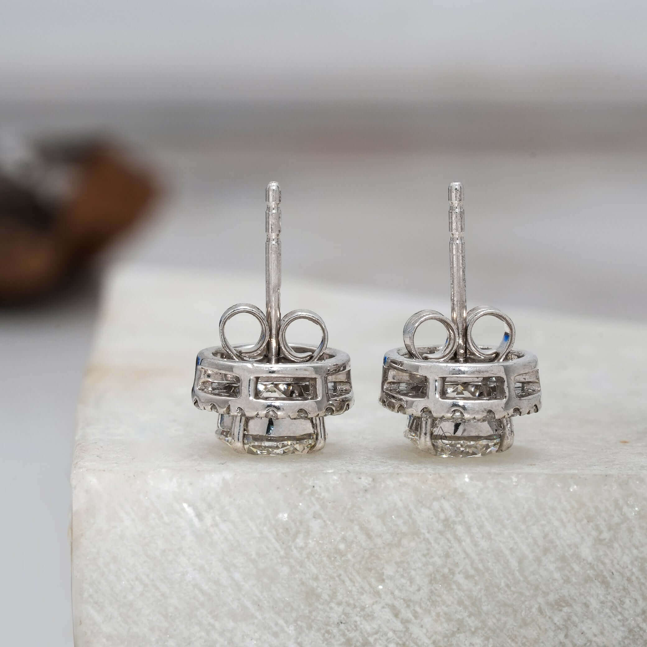 Round diamond halo earrings with brilliant diamonds in a secure setting.