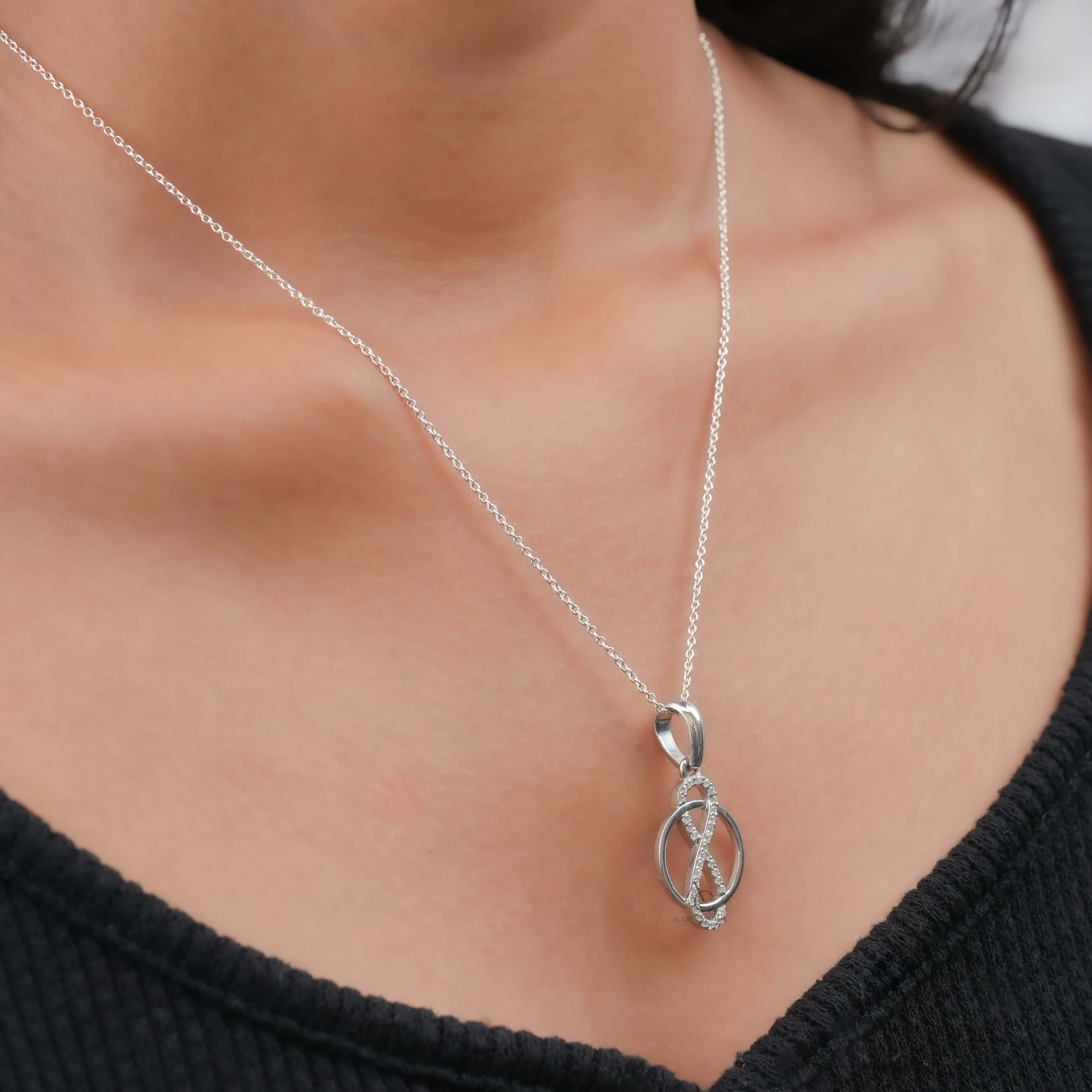 Infinity circle pendant featuring lab grown diamonds, worn on neck, showcasing elegance and sustainable luxury.