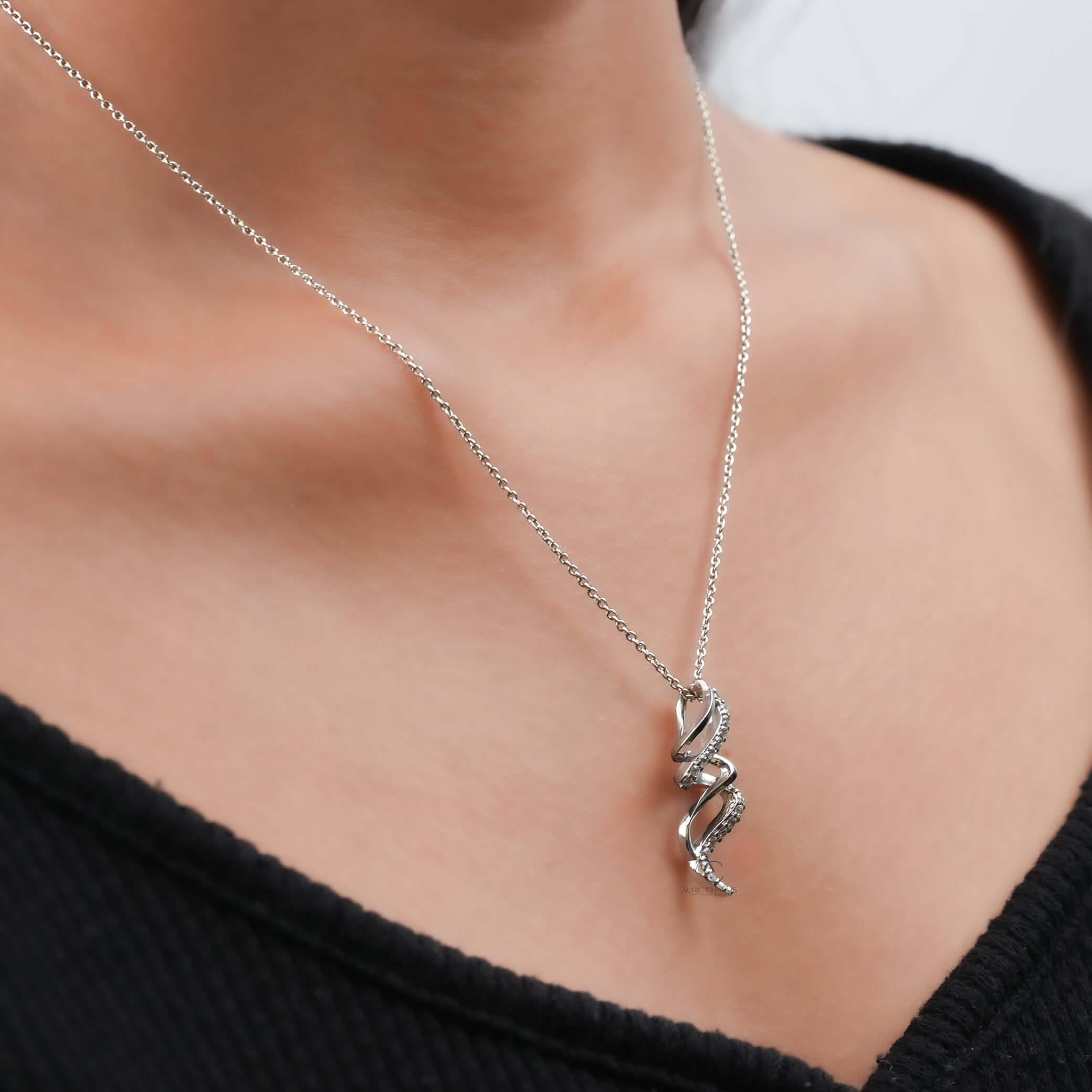A luxurious spiral diamond pendant worn on the neck, showcasing its lab-grown diamonds and elegant design.