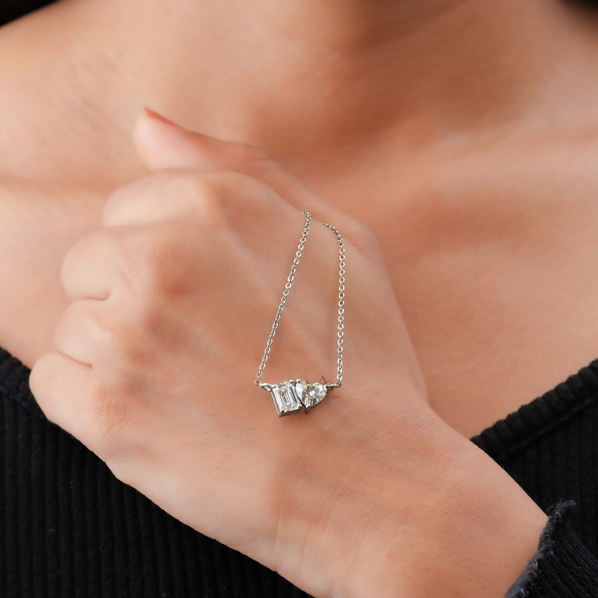Lab grown diamond Toi et Moi pendant, featuring Emerald and Heart cuts, elegantly worn on the neck for a luxurious look.
