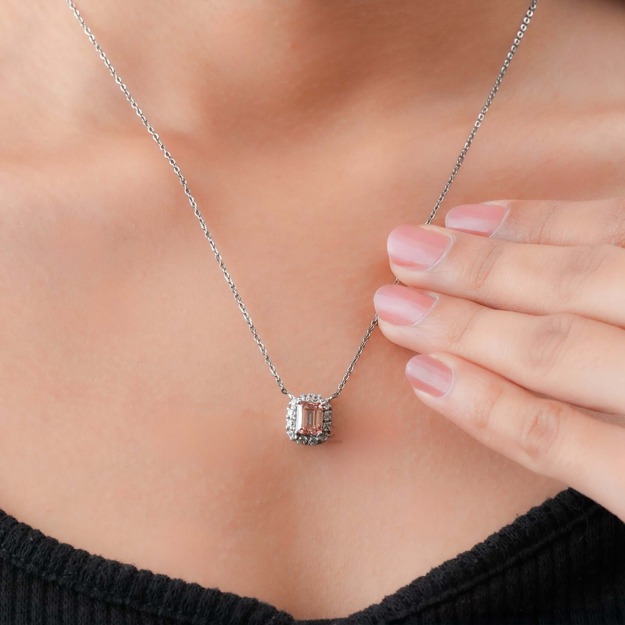 Worn on neck, this luxury lab-grown diamond halo pendant showcases a fancy pink emerald cut surrounded by brilliance.