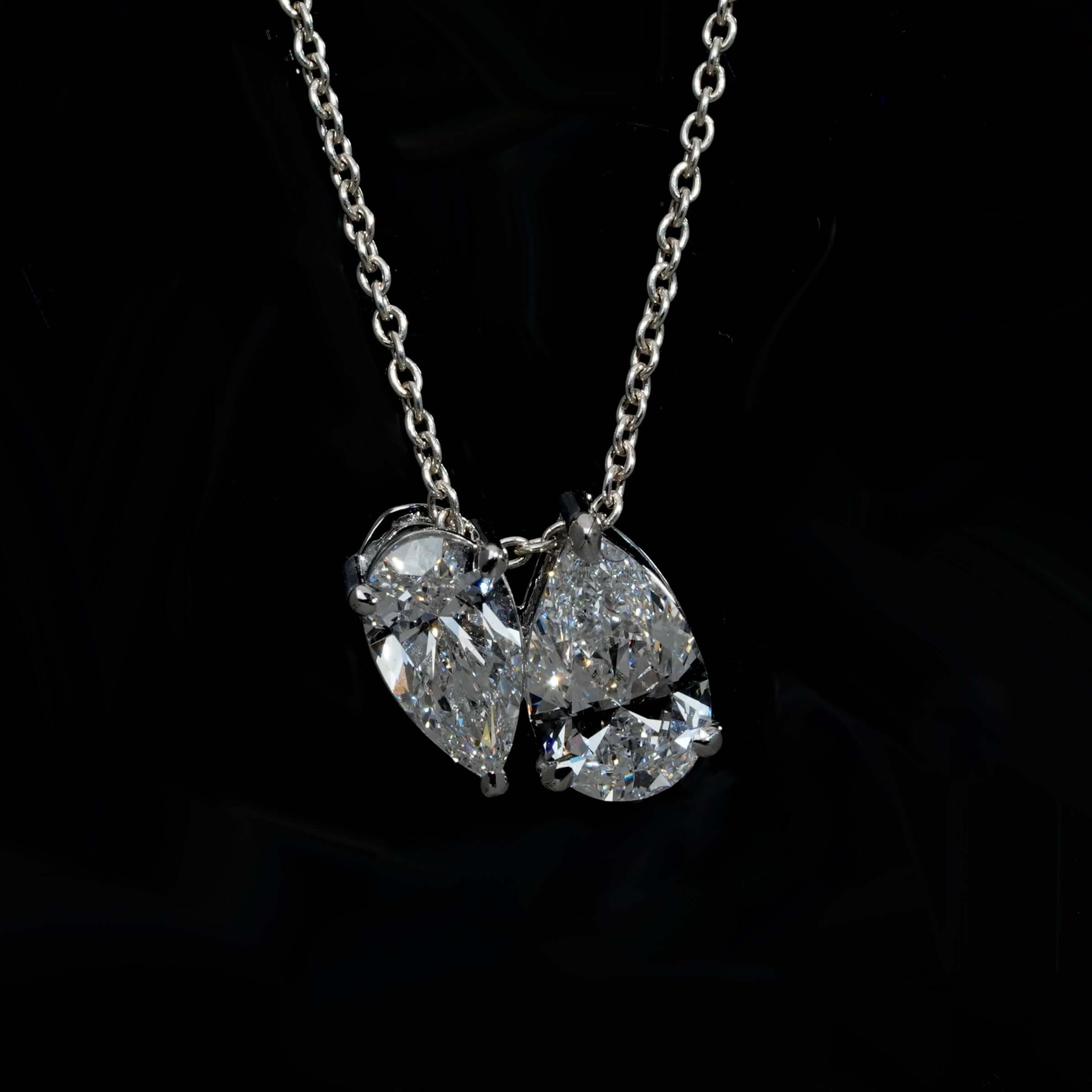Luxurious Toi et Moi Pear Cut Lab Grown Diamond pendant necklace, showcasing elegance, worn on a delicate chain.