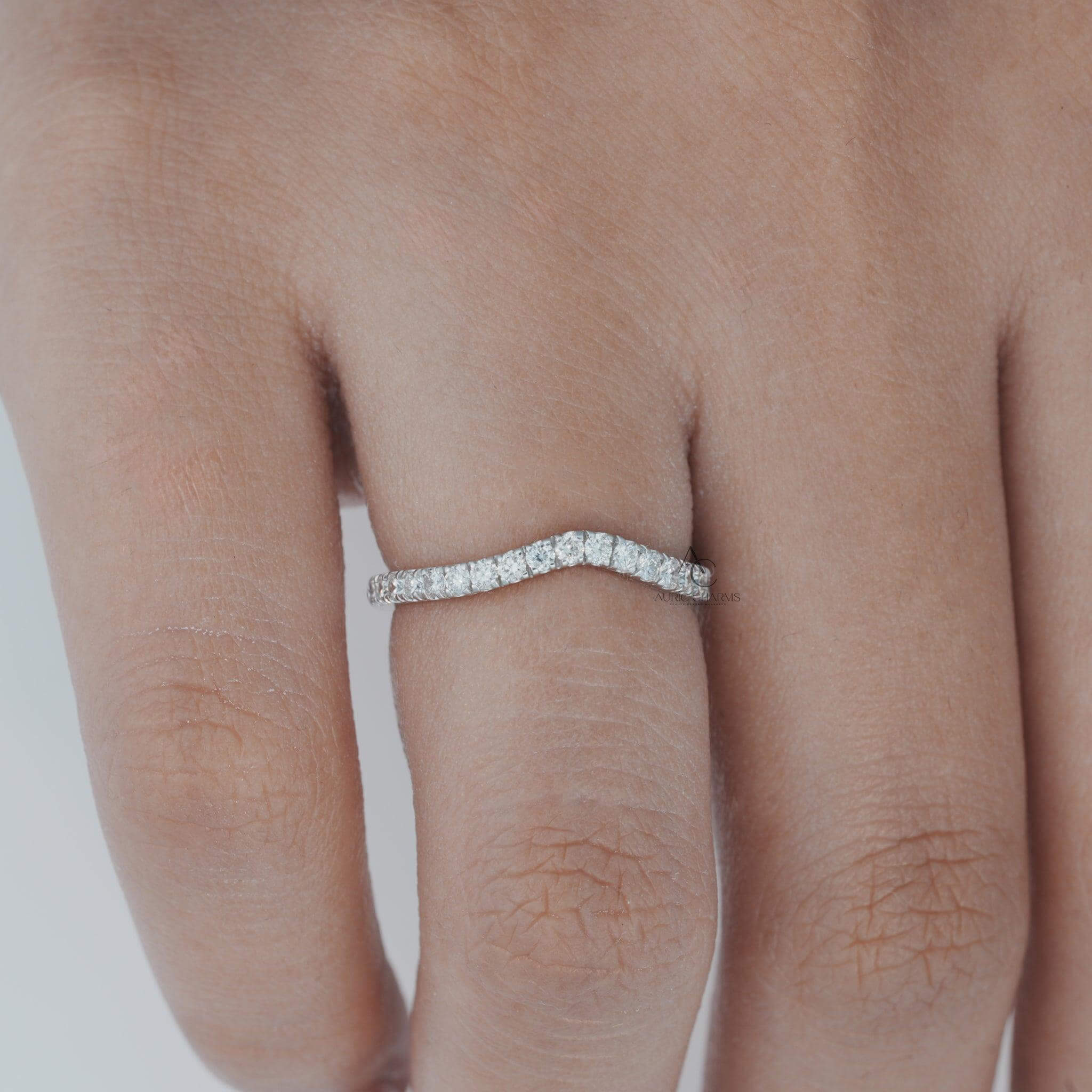 Wavy diamond ring showcased on finger, highlighting its sleek and refined design.