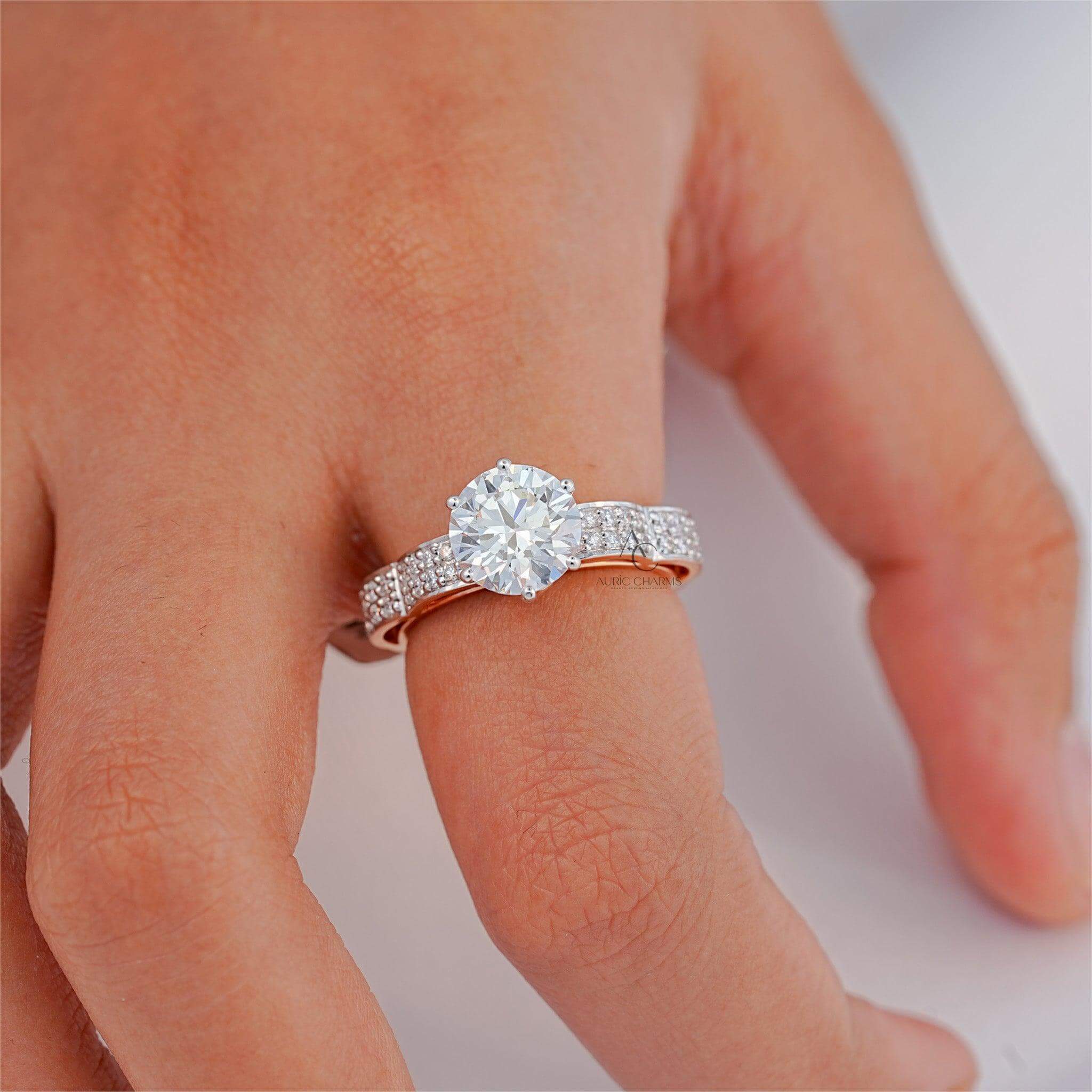 Elegant diamond ring with a round center stone on a hand.