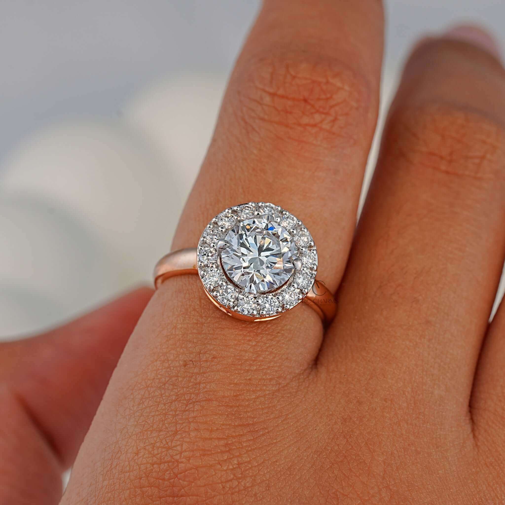 Double halo round diamond ring with pave band displayed on a finger.