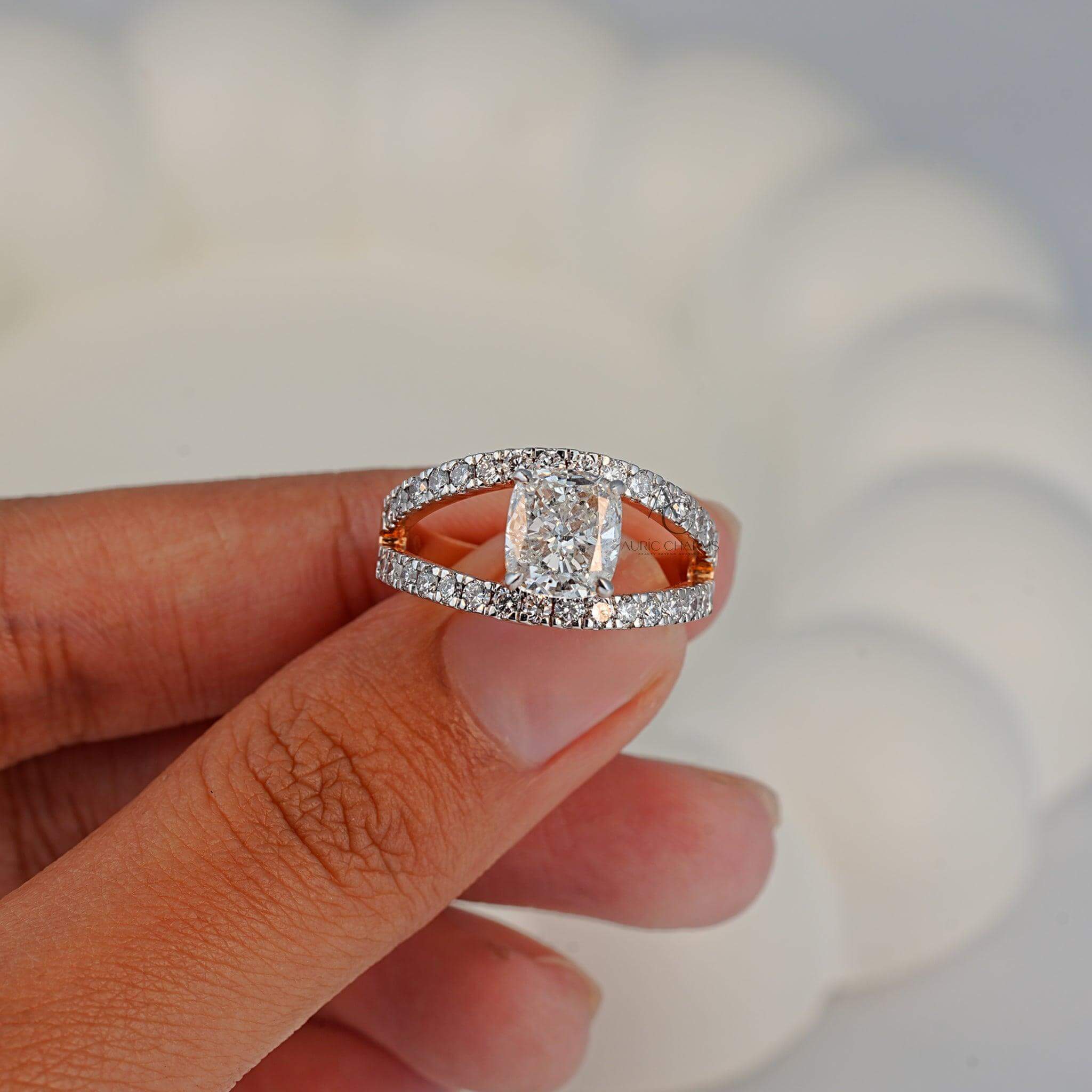 Close-up view of a diamond ring with a radiant center stone, set in a sleek rose-gold double-band design