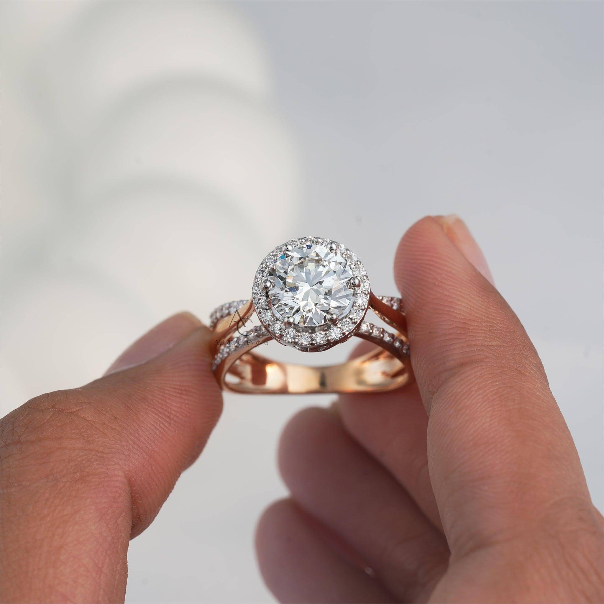 Hand holding round halo diamond engagement ring in rose gold, showcasing brilliance.