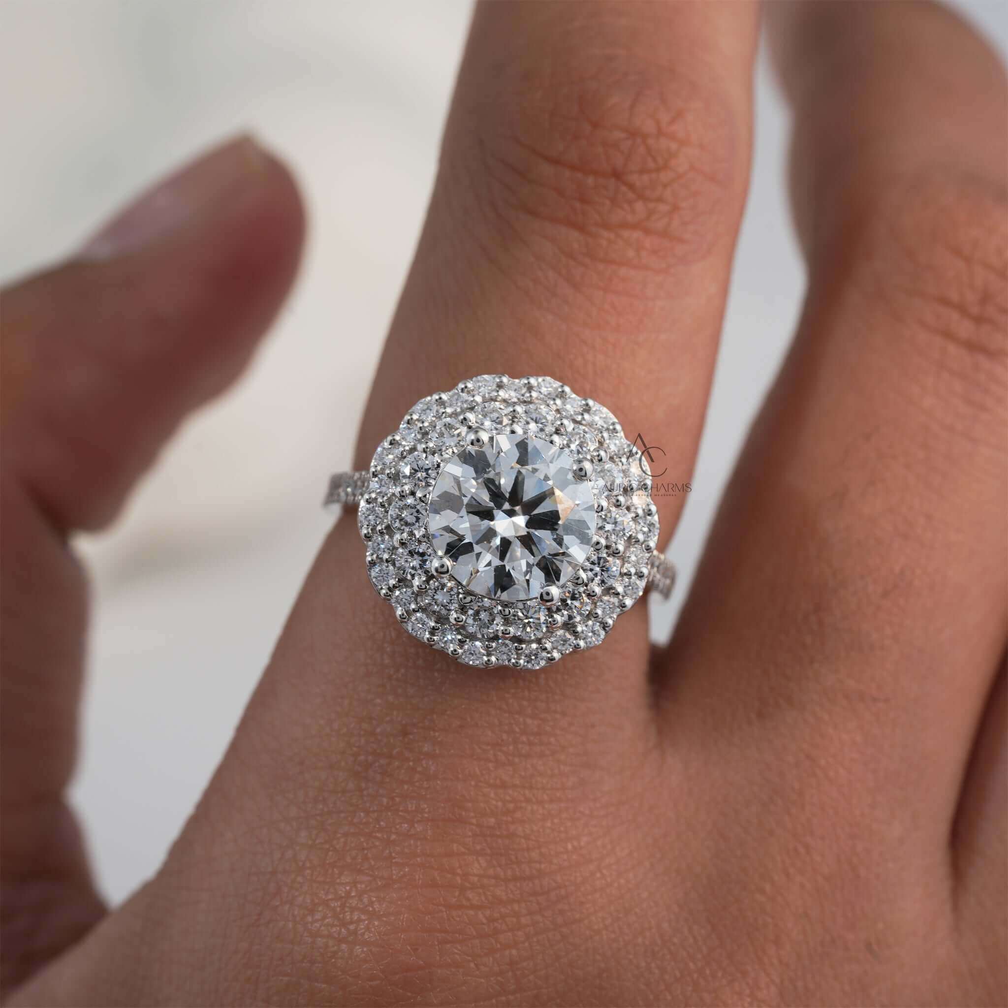 Lab-grown diamond floral halo ring on finger with intricate setting design.