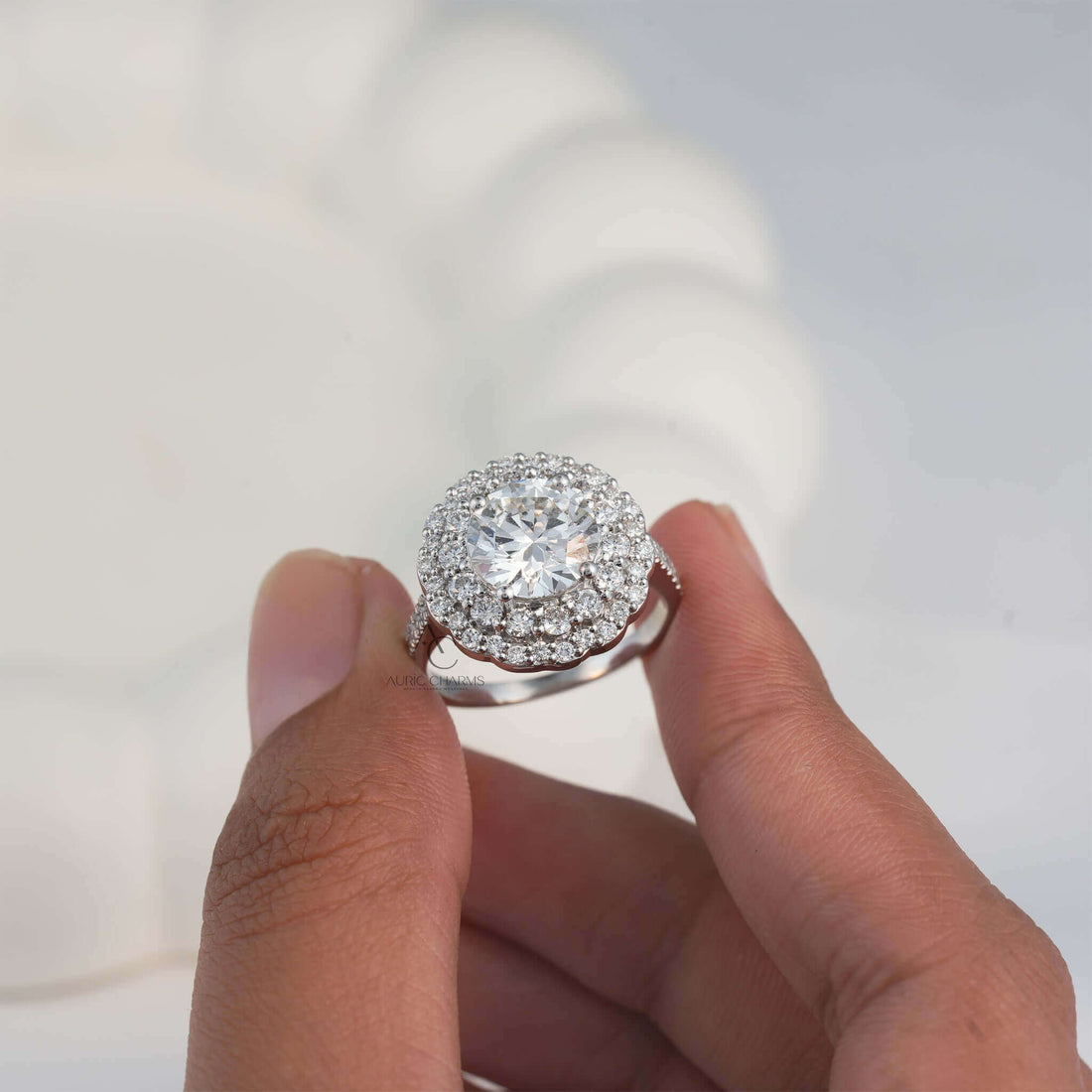 Elegant lab-grown diamond floral halo ring held close to showcase 